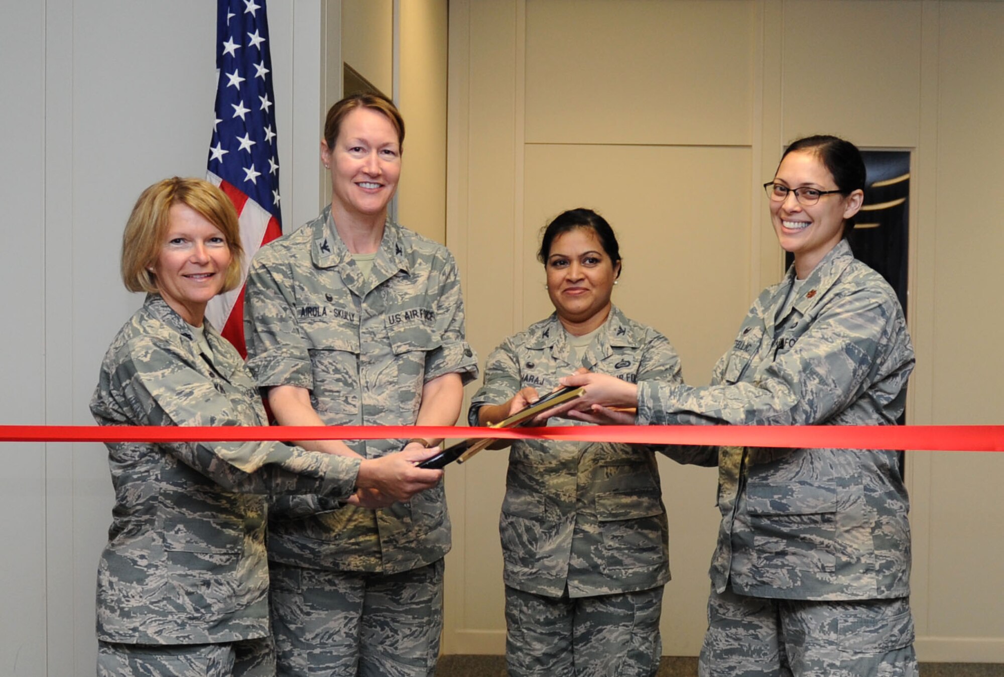 Lt. Col. Teresa King, 81st Force Support Squadron commander, Col. Susan Airola-Skully, 81st Mission Support Group commander, Col. Beena Maharaj, 403rd MSG commander and Maj. Lisa Kostellic, 403rd FSS commander, pose for a photo during an Integrated Personnel Management Initiative (IPM-I) ribbon cutting ceremony at the Sablich Center March 8, 2016, Keesler Air Force Base, Miss. The purpose of the 81st and 403rd Force Support Squadrons’  efforts at Keesler is to achieve a more capable and efficient organization to serve active duty and Reserve Airmen, their families and retirees who utilize FSS services. This effort was directed by the Secretary of the Air Force. (U.S. Air Force photo by Kemberly Groue)