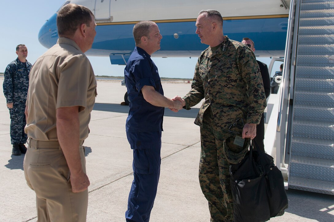 Marine Corps Gen. Joseph F. Dunford Jr., right, chairman of the Joint Chiefs of Staff, exchanges greetings with Coast Guard Rear Adm. Chris Tomney, director of Joint Interagency Task Force South, at Naval Air Station Key West, Fla., March 8, 2016. The task force conducts interagency and international detection and monitoring operations, and facilitates the interdiction of illicit trafficking and other narcoterrorist threats to support national and partner nation security. DoD photo by Navy Petty Officer 2nd Class Dominique A. Pineiro