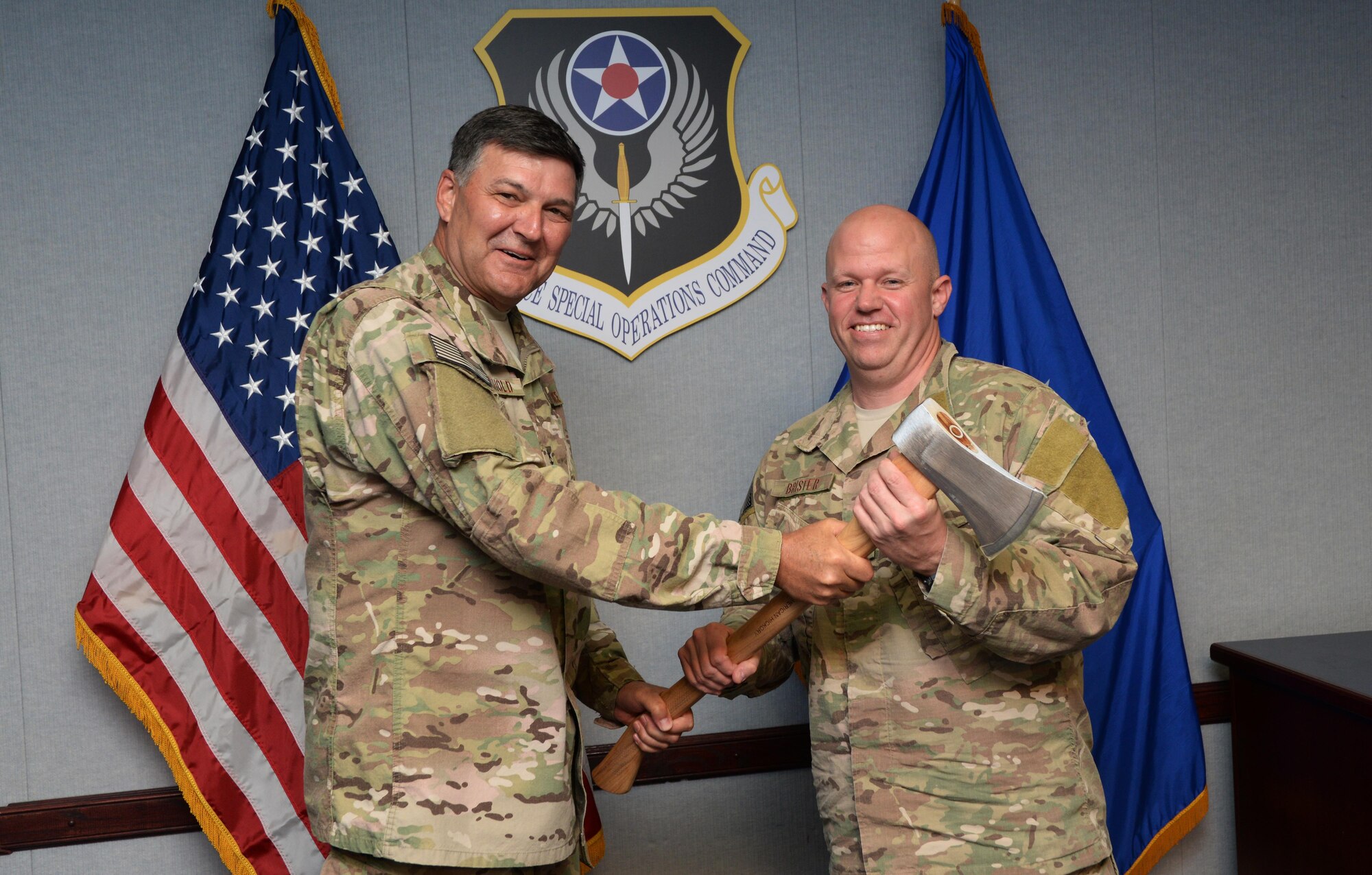 Lt. Gen. Brad Heithold, Air Force Special Operations Command commander, presents Lt. Col. Paul Brister, 23rd Special Tactics Squadron commander, an engraved axe at the conclusion of the 2025 Strategic Initiative Competition at Hurlburt Field, Fla., Feb. 29, 2016. Brister and Capt. Jesse Gault, 23rd STS Gold Team flight commander, beat nearly 60 other entries with their concept of “SpecOps Swarms.” (U.S. Air Force photo/Mike Raynor)