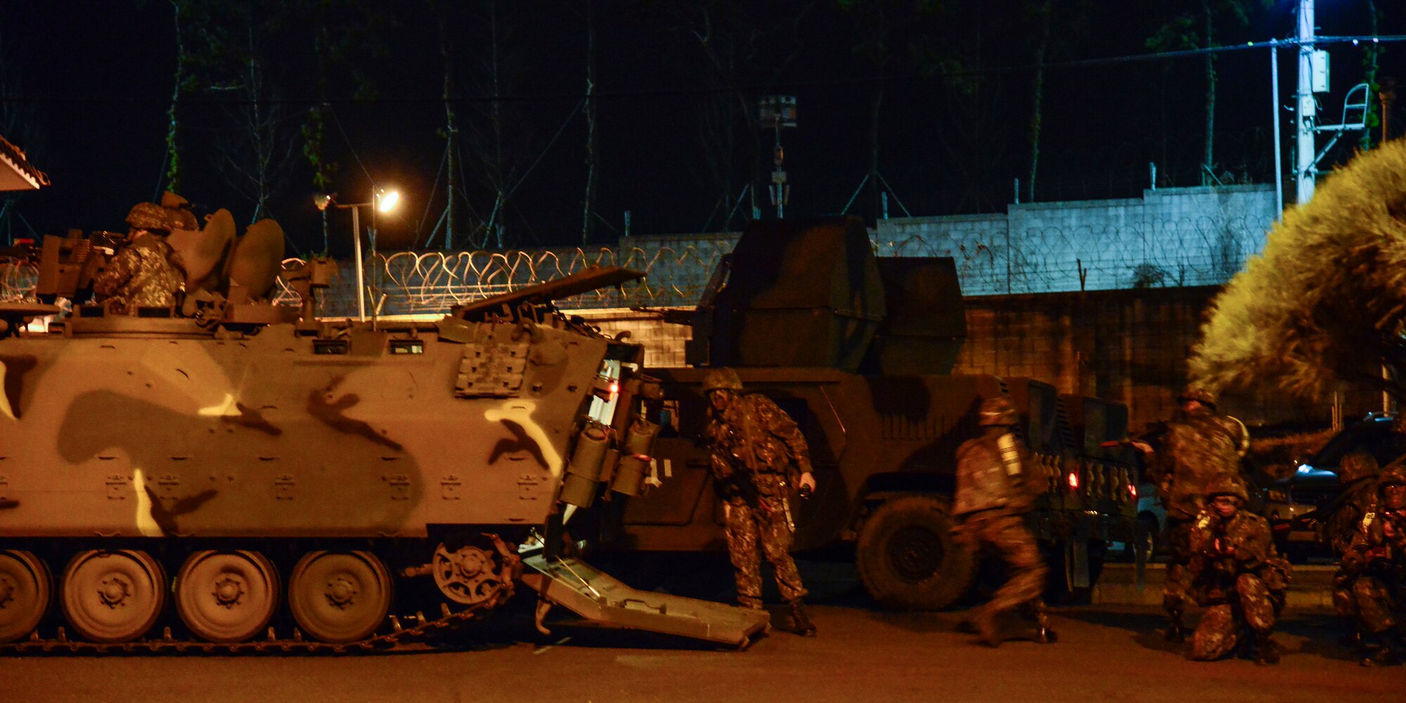 Republic of Korea Air Force personnel run into place as U.S. Air Force defenders provide cover from a Humvee during a simulated attack in conjunction with exercise Beverly Midnight 16-01 on Osan Air Base, South Korea, March 9, 2016. During the exercise, the ROKAF military police and U.S. Air Force defenders conducted opposing forces training, integrating defense techniques. (U.S. Air Force photo by Senior Airman Kristin High/Released)