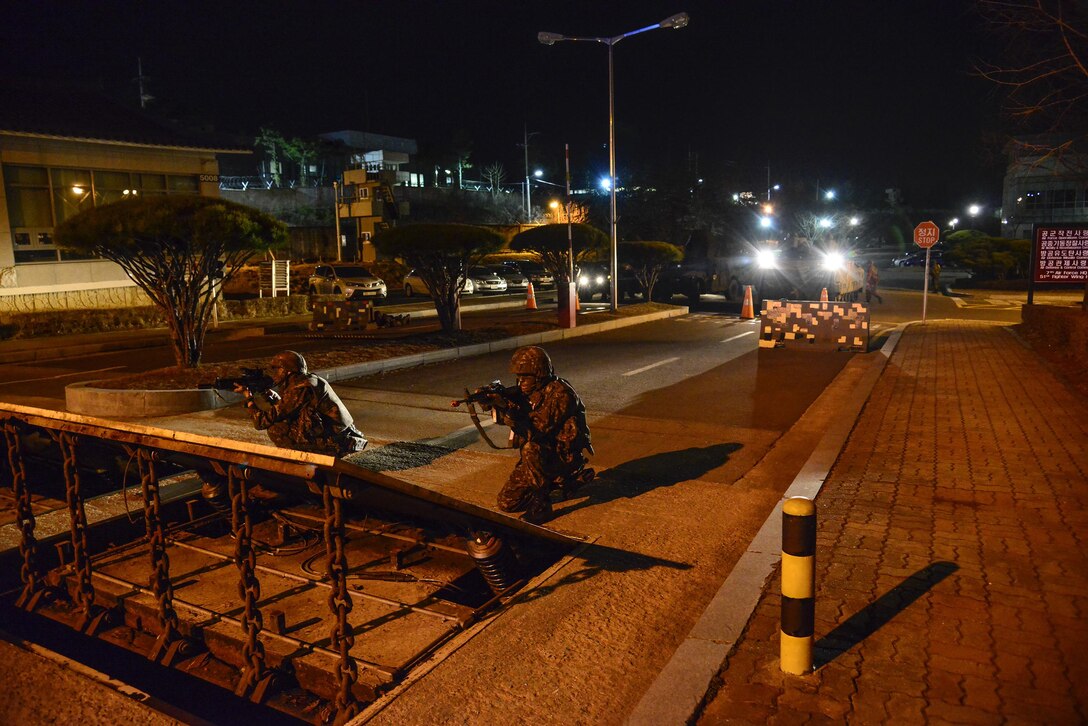 Republic of Korea Air Force personnel guard the perimeter of the base during a simulated attack in conjunction with exercise Beverly Midnight 16-01 on Osan Air Base, South Korea, March 9, 2016. During the exercise, the ROKAF military police and U.S. Air Force defenders conducted opposing forces training, integrating defense techniques. (U.S. Air Force photo by Senior Airman Kristin High/Released)