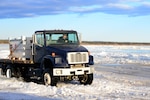 Tech. Sgt. John Jockusch, the 354th Civil Engineer Squadron noncommissioned officer in charge of range structural maintenance, drives a truck over the ice bridge in Delta Junction, Alaska, March 2, 2016. The ice bridge is used to get to and from the Oklahoma Range, part of RED FLAG-Alaska’s strategic training area, and is built by Airmen, soldiers and DoD civilians. 