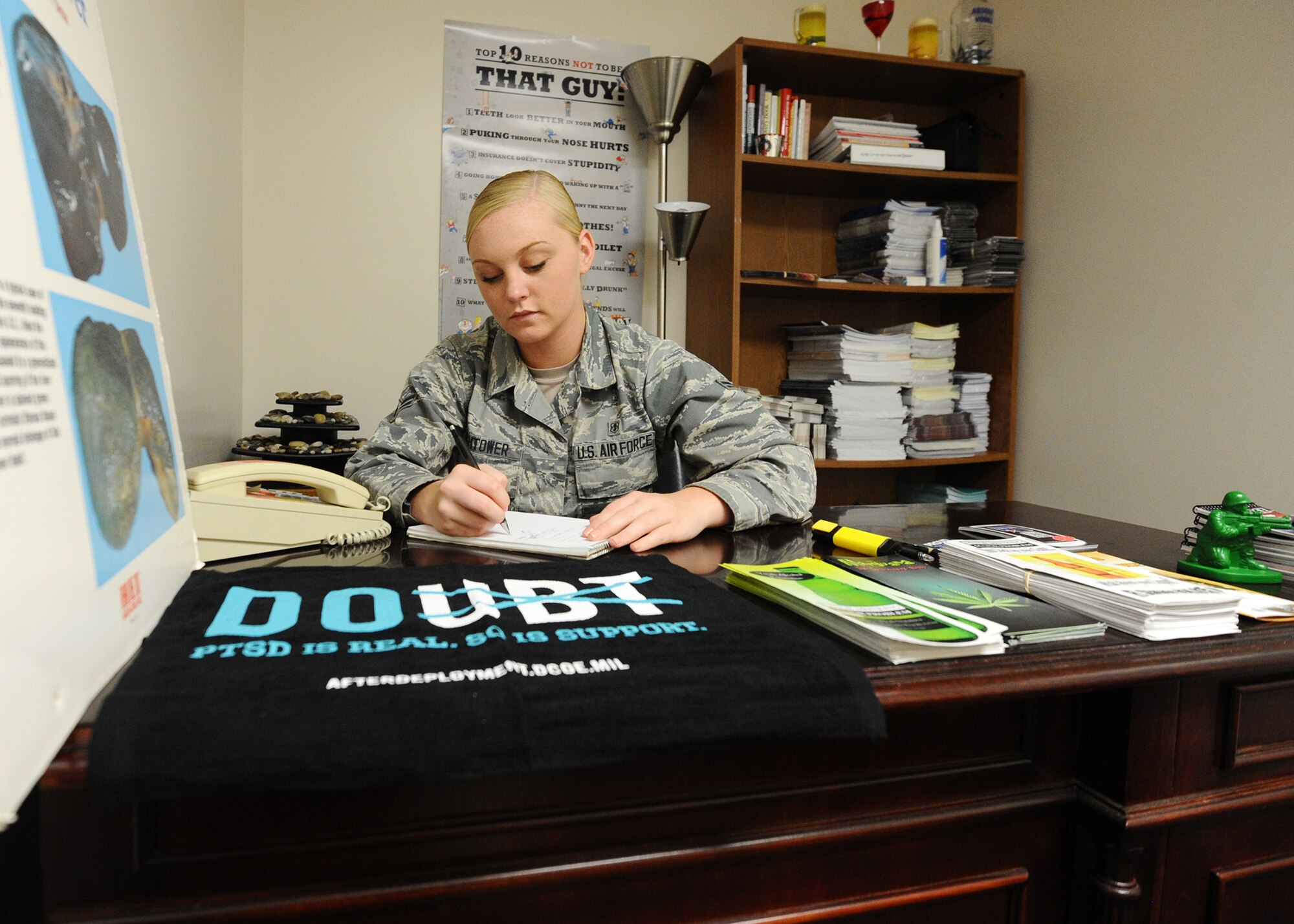 Airman 1st Class Katlin Hightower, 325th Medical Operations Squadron mental health technician, makes preparations for an upcoming Alcohol Drug Abuse Prevention Treatment outreach presentation March 8 at the Mental Health facility. Hightower is a native of Mooresville, Missouri, a graduate of the Southwest Livingston County R-1 School District located in Ludlow, Missouri, and the first person in her family to join the military. (U.S. Air Force photo by Senior Airman Ty-Rico Lea/Released)