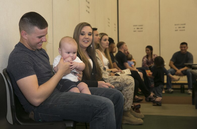 Pfc. Braxton Peirce, radio operator, 2nd Battalion, 7th Marine Regiment, plays with his son Reminton, 6 months, before the units’ pre-deployment brief at building 1707 aboard the Combat Center, March 2, 2016. (Official Marine Corps photo by Cpl. Thomas Mudd/Released)