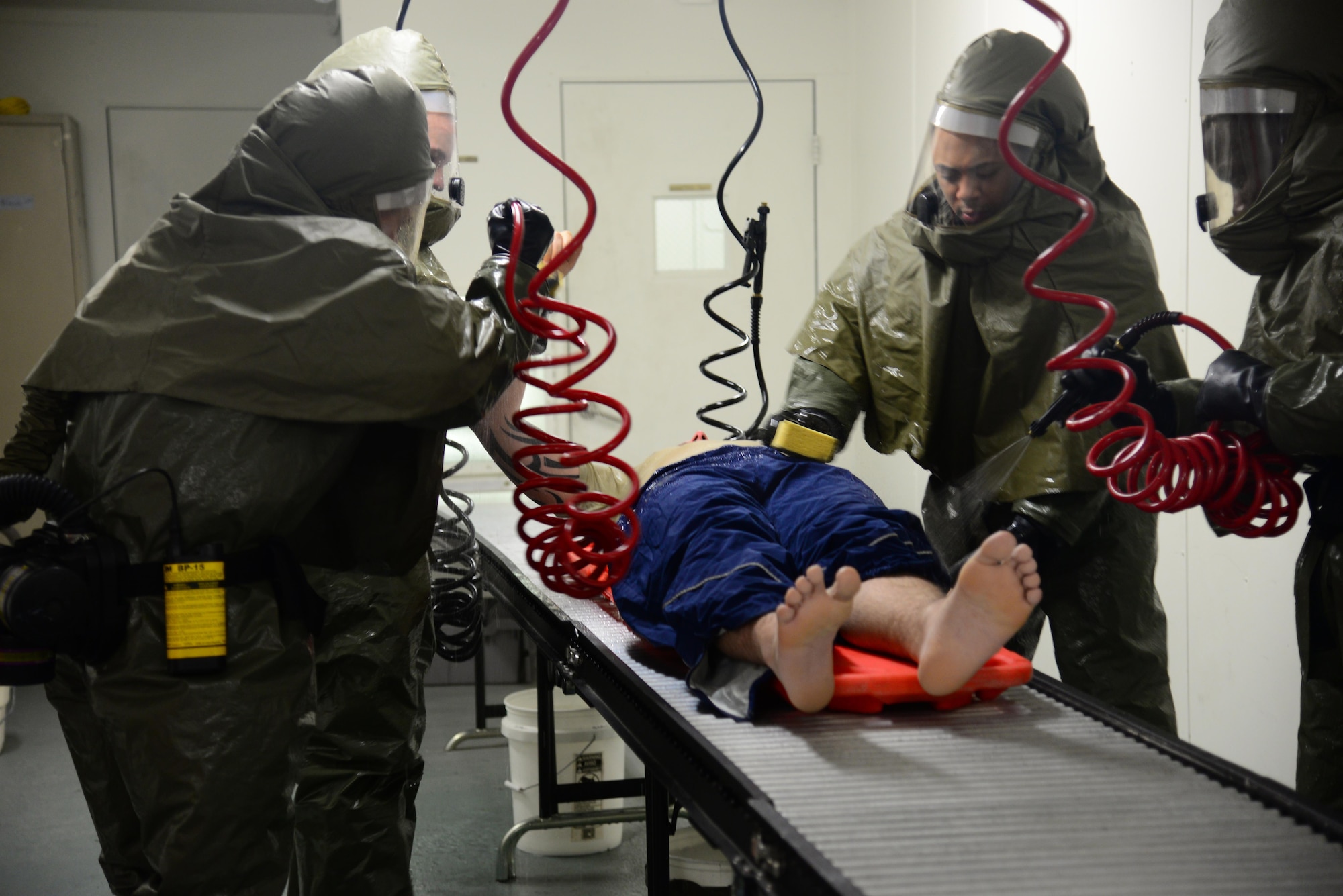 A patient decontamination team washes a simulated patient in the contamination control area of the 51st Medical Group during exercise Beverly Midnight 16-01, Osan Air Base, Republic of Korea, March 8, 2016. The medical treatment facility here has the only fully functioning built-in CCA in the Air Force to allow medical personnel to attend to patients faster. (U.S. Air Force photo by Staff Sgt. Rachelle Coleman/Released)