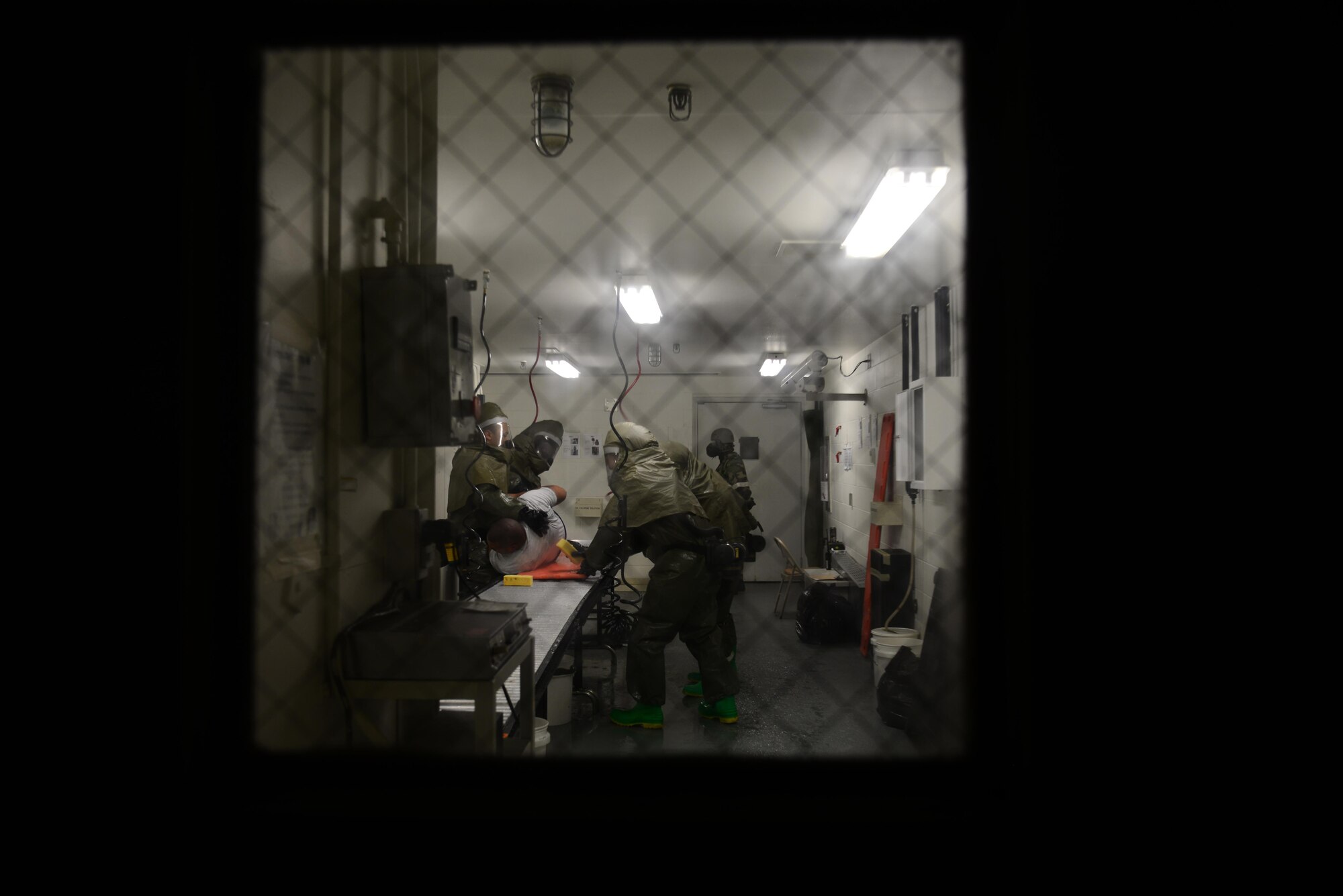 A patient decontamination team washes a simulated patient in the contamination control area of the 51st Medical Group during exercise Beverly Midnight 16-01, Osan Air Base, Republic of Korea, March 8, 2016. The medical treatment facility here has the only fully functioning built-in CCA in the Air Force to allow medical personnel to attend to patients faster. (U.S. Air Force photo by Staff Sgt. Rachelle Coleman/Released)