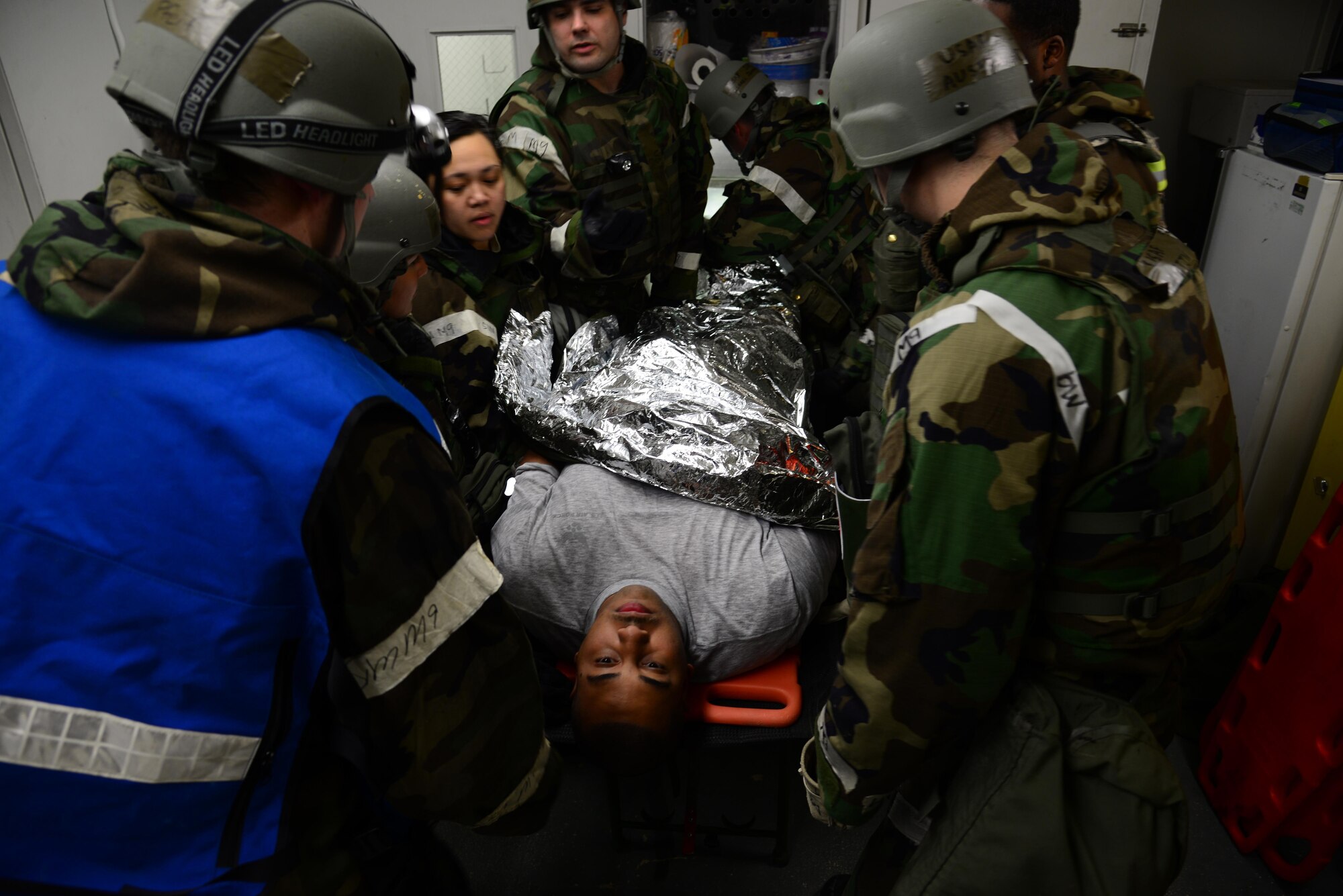 Medical personnel inside the clinic pull a simulated patient out of an air lock after being processed through the contamination control area during Exercise Beverly Midnight 16-01, Osan Air Base, Republic of Korea, March 8, 2016. Patients are transferred to the appropriate treatment area within the facility for further medical attention after being decontaminated. (U.S. Air Force photo by Staff Sgt. Rachelle Coleman/Released)
