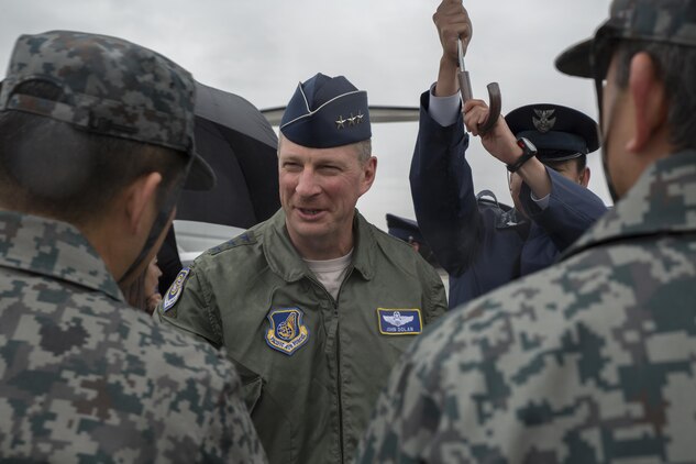 Lt. Gen. John L. Dolan, commander of U.S. Forces Japan and 5th Air Force, greets Japanese Air Self-Defense Force members during a visit to Komatsu Air Base, Japan, March 9, 2016. Dolan visited in support of the Komatsu Aviation Training Relocation exercise. The ATR program implemented in 2007, increases operational readiness while improving interoperability and reducing local noise impacts at U.S. bases in Japan. (U.S. Marine Corps photo by Cpl. Nicole Zurbrugg/Released)