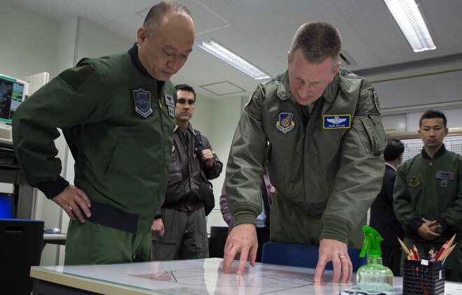 Japan Air Self-Defense Force Gen. Kenichiro Nagumo, 6th Air Wing commanding general, and U.S. Air Force Lt. Gen. John L. Dolan, commander of U.S. Forces Japan and 5th Air Force, study a flight diagram during a visit to Komatsu Air Base, Japan, March 9, 2016. Dolan visited Komatsu Air Base for the first time to observe the Komatsu Aviation Training Relocation exercise between Marine Fighter Attack Squadron (VMFA) 314 and the Japan Air Self-Defense Force. The ATR program has three main goals: to increase operational readiness, improve interoperability, and reduce local noise impacts. (U.S. Marine Corps photo by Cpl. Nicole Zurbrugg/Released)