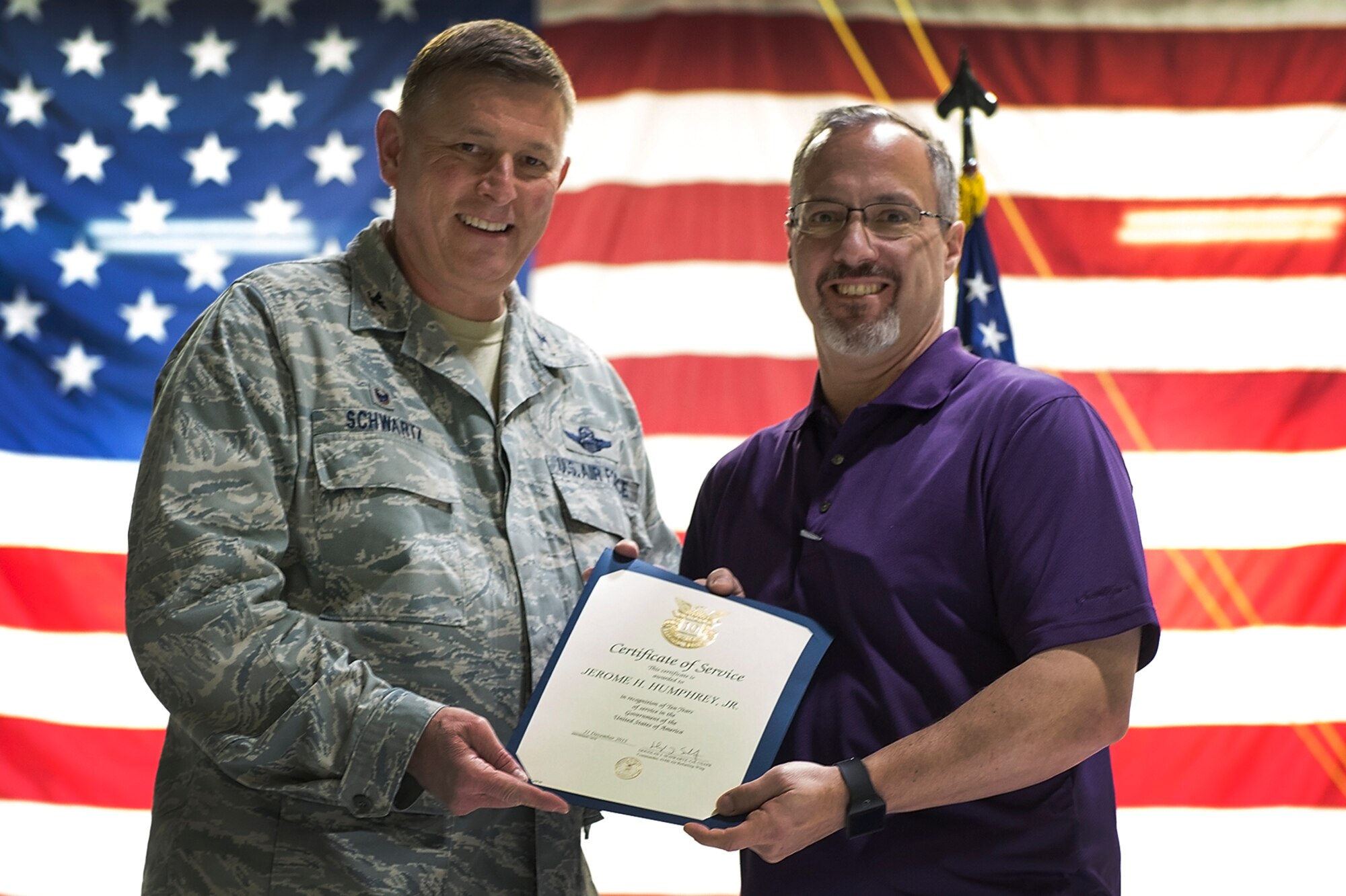 Jerry Humphrey, 434th Communications Squadron information manager, right, receives a certificate for 30 years of federal service March 9, 2016 at Grissom Air Reserve Base, Ind. Humphrey was one of several individuals recognized for longevity and quarterly awards at the civilian commander’s call. (U.S. Air Force photo/Douglas Hays)