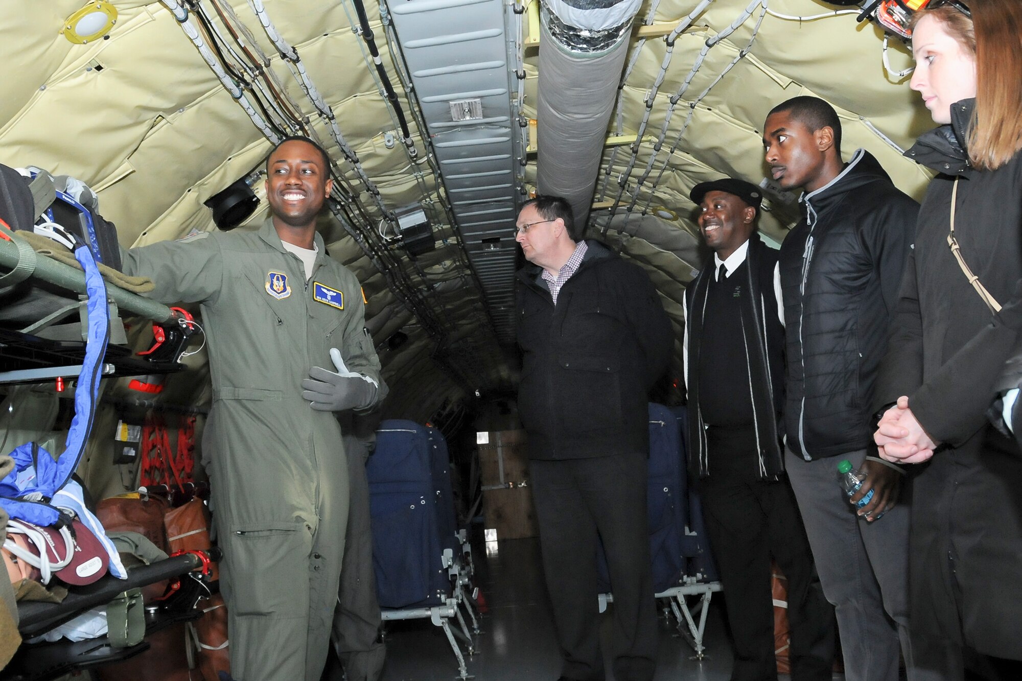 Senior Airman Kevin Campbell, 459th Aeromedical Evacuation Squadron aeromedical evacuation technician, illustrates his unit’s mission to a group of Baltimore Ravens staff members inside a KC-135R Stratotanker during a tour on the Joint Base Andrews, Maryland, flight line March 7, 2016. The 459th also showcased missions such as inflight refueling, maintenance and aerial porting. (U.S. Air Force photo/Staff Sgt. Kat Justen)