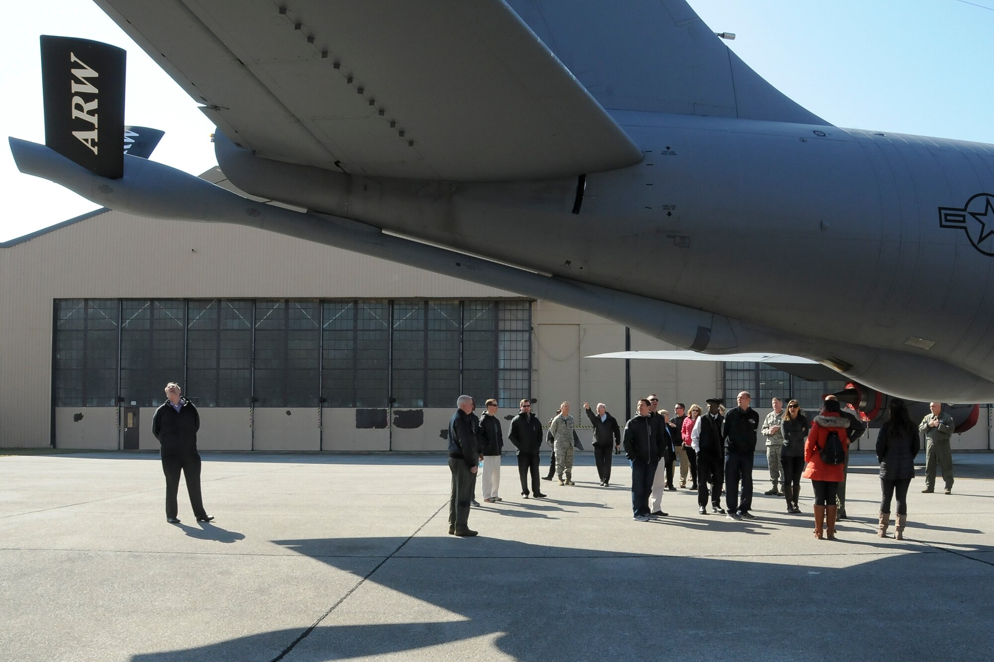 Members of the Batlimore Ravens staff observe the tail section and refueling boom on a 459th Air Refueling Wing KC-135R Stratotanker during a tour on the Joint Base Andrews, Maryland, flight line March 7, 2016. The 459th also showcased missions to the group such as inflight refueling, maintenance, aerial port and aeromedical evacuation. (U.S. Air Force photo/Staff Sgt. Kat Justen)