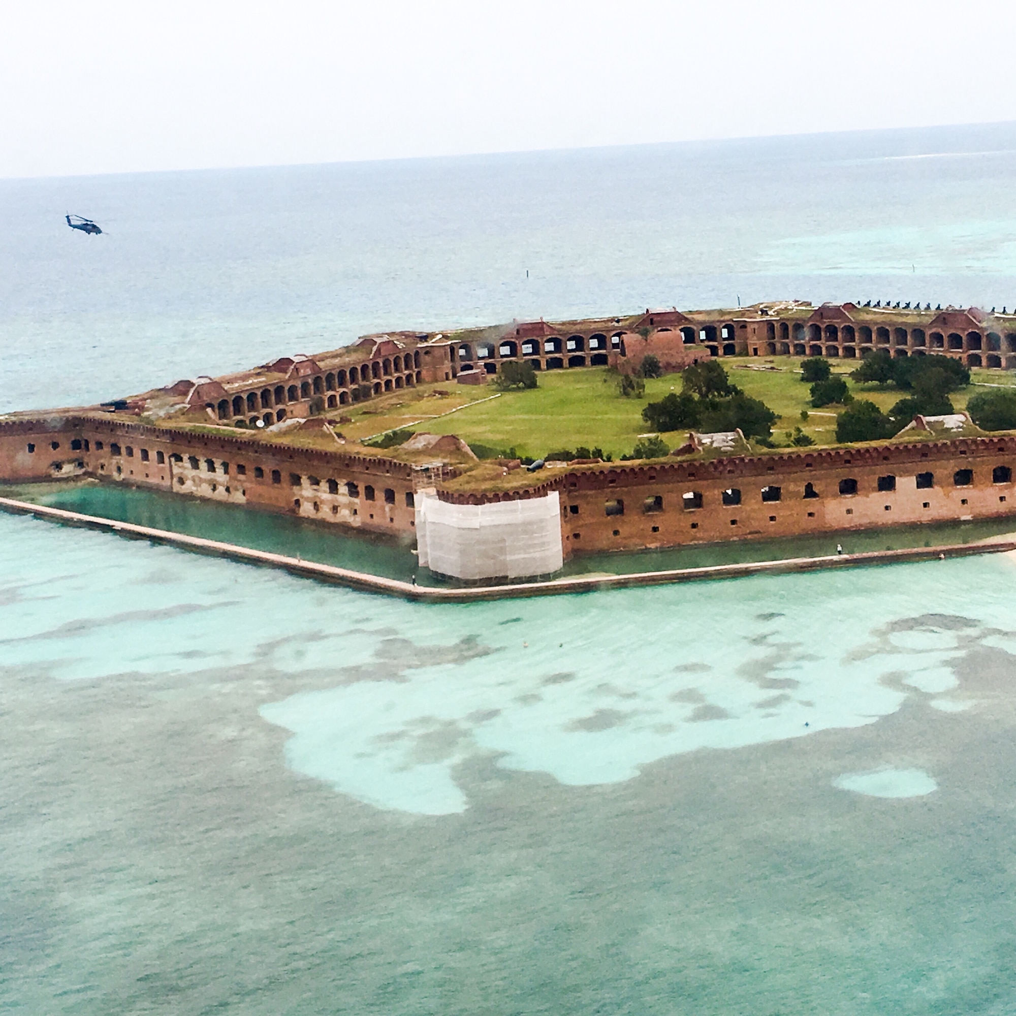 An HH-60 Pave Hawk helicopter flies over Fort Jefferson, Dry Tortugas National Park, Fla., March 5, 2016. Rescue Airmen from the 920th Rescue Wing, Patrick Air Force Base, Fla., were there to train alongside Canadian rescue personnel during the annual search-and-rescue exercise. (courtesy photo)