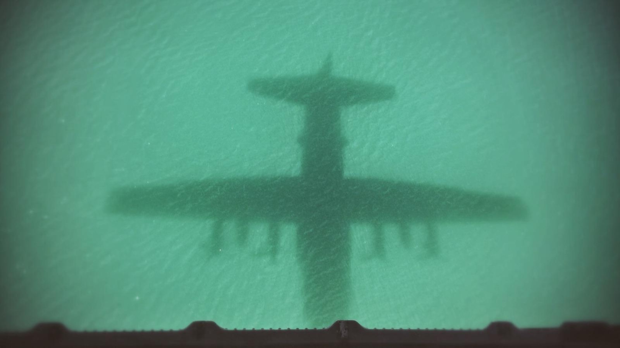 An HC-130 King shadow appears in the waters off Key West, Fla., March 5, 2016. Rescue Airmen from the 920th Rescue Wing, Patrick Air Force Base, Fla., were there to train alongside Canadian rescue personnel during the annual search-and-rescue exercise. (courtesy photo)