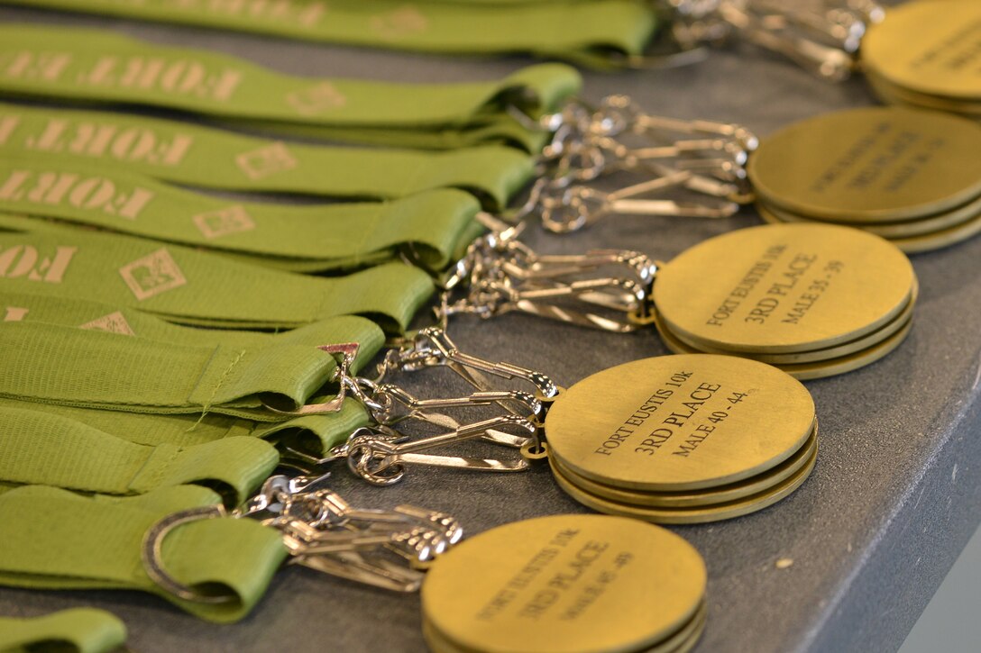 Medallions line a table during the 18th Annual Fort Eustis 10K Run at Fort Eustis, Va., March 5, 2016. The race led runners along the James River and past the historic Matthew Jones House. (U.S. Air Force photo by Staff Sgt. Natasha Stannard)