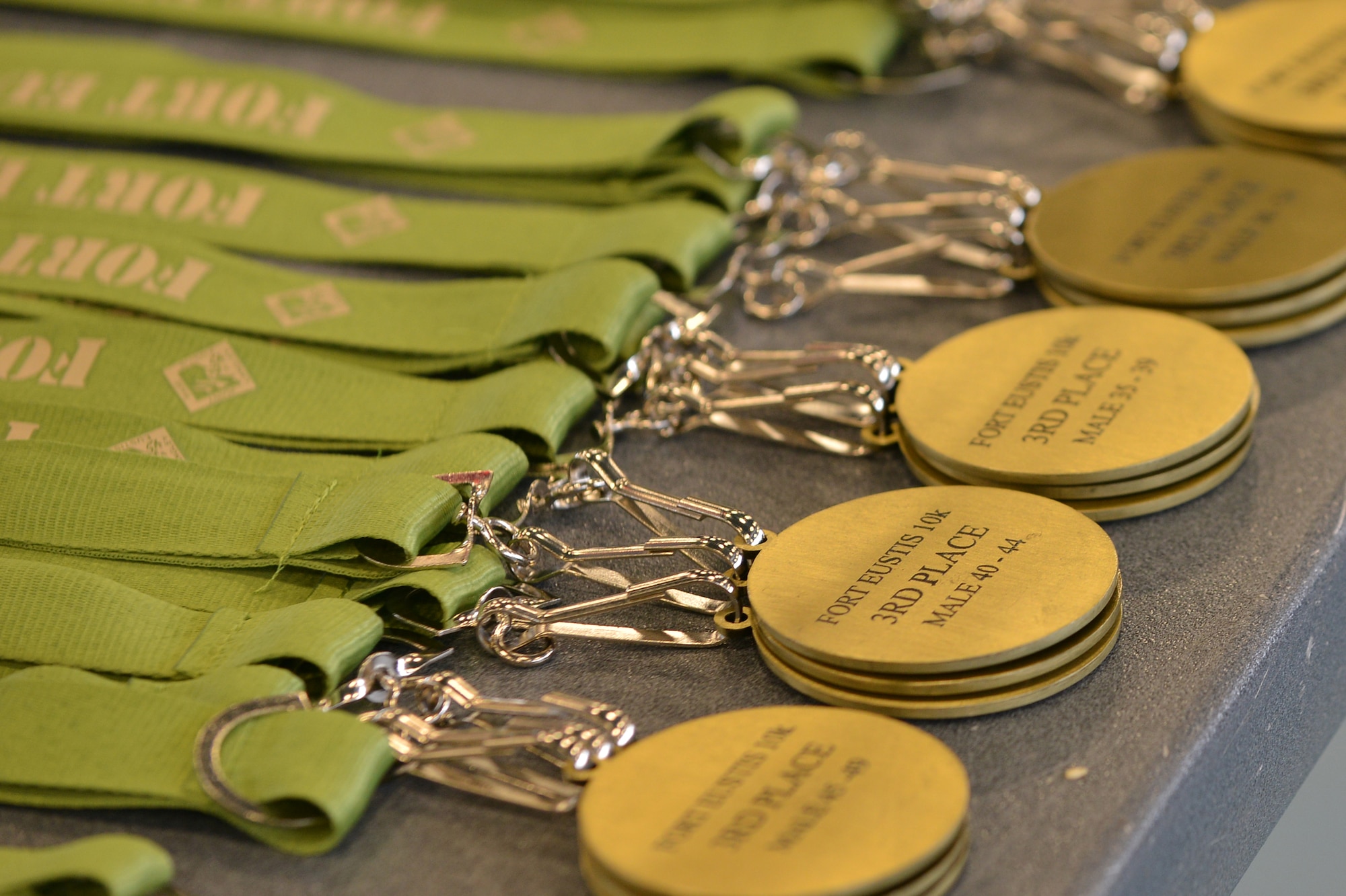 Medallions line a table during the 18th Annual Fort Eustis 10K Run at Fort Eustis, Va., March 5, 2016. The race led runners along the James River and past the historic Matthew Jones House. (U.S. Air Force photo by Staff Sgt. Natasha Stannard)