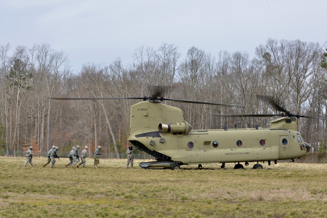 U.S. Army Soldier’s with the 558th Transportation Company practice carrying casualties to a CH-47 Chinook helicopter during an exercise at Fort Eustis, Va., March 3, 2016. During the exercise, the company assessed, treated and evacuated casualties in an austere environment. (U.S. Air Force photo by Staff Sgt. Natasha Stannard)