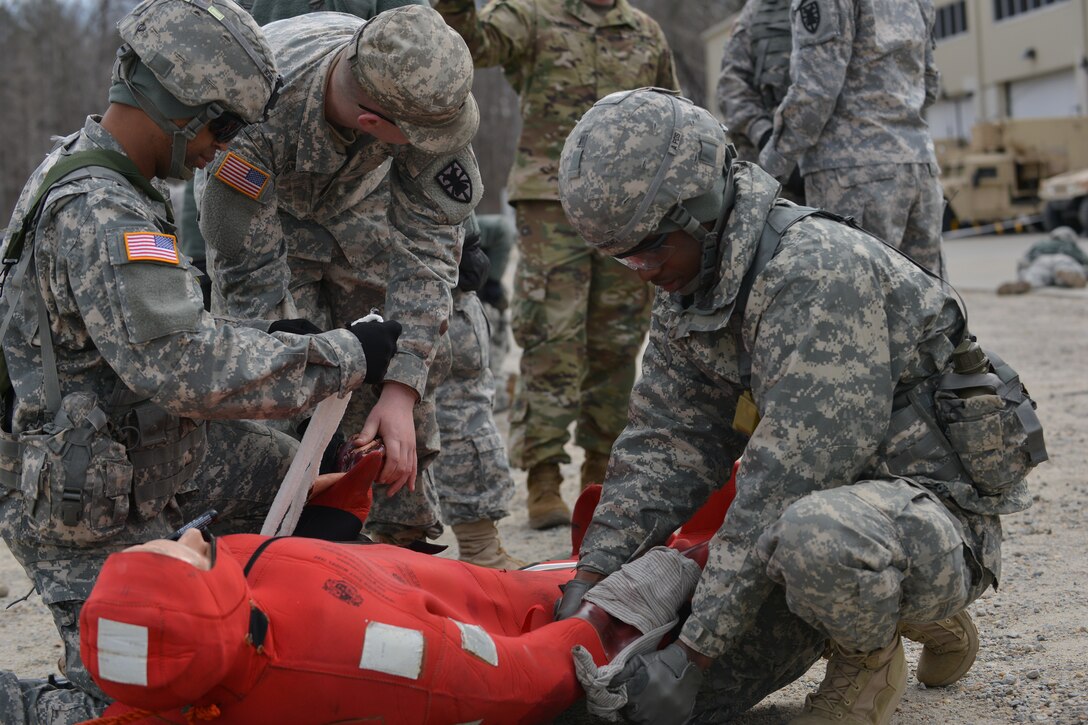 U.S. Army Soldiers with the 558th Transportation Company treat a simulated casualty wearing a survival suit during an exercise at Fort Eustis, Va., March 3, 2016. The Soldiers must be equipped to aid injured seafaring Service members. (U.S. Air Force photo by Staff Sgt. Natasha Stannard)
