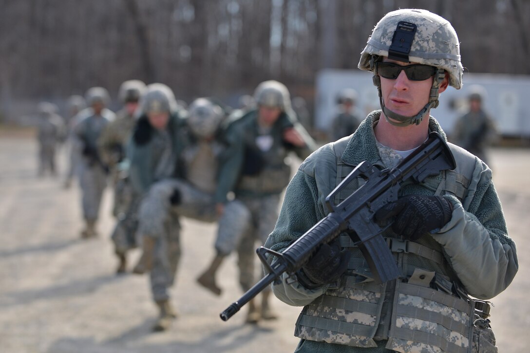 U.S. Army Soldiers with the 558th Transportation Company practice casualty carry skills, as fellow company members secure the perimeter during a casualty evacuation exercise at Fort Eustis, Va., March 3, 2016.  The company went through several casualty scenarios in which they practiced various carrying methods with and without a litter. (U.S. Air Force photo by Staff Sgt. Natasha Stannard)