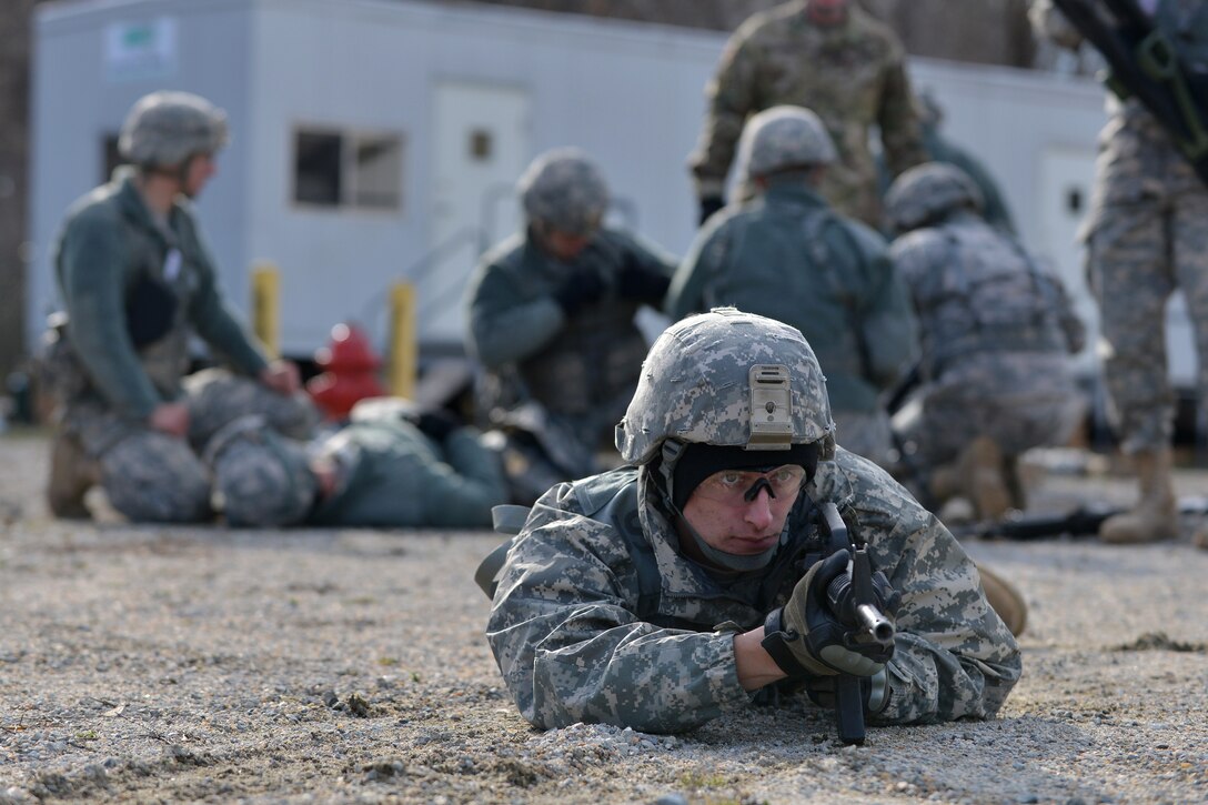A U.S. Army Soldier with the 558th Transportation Company provides security for simulated injured team members during a casualty evacuation exercise at Fort Eustis, Va., March 3, 2016.  After casualties were treated they were moved for transport by helicopter, during which the detail provided security. (U.S. Air Force photo by Staff Sgt. Natasha Stannard)