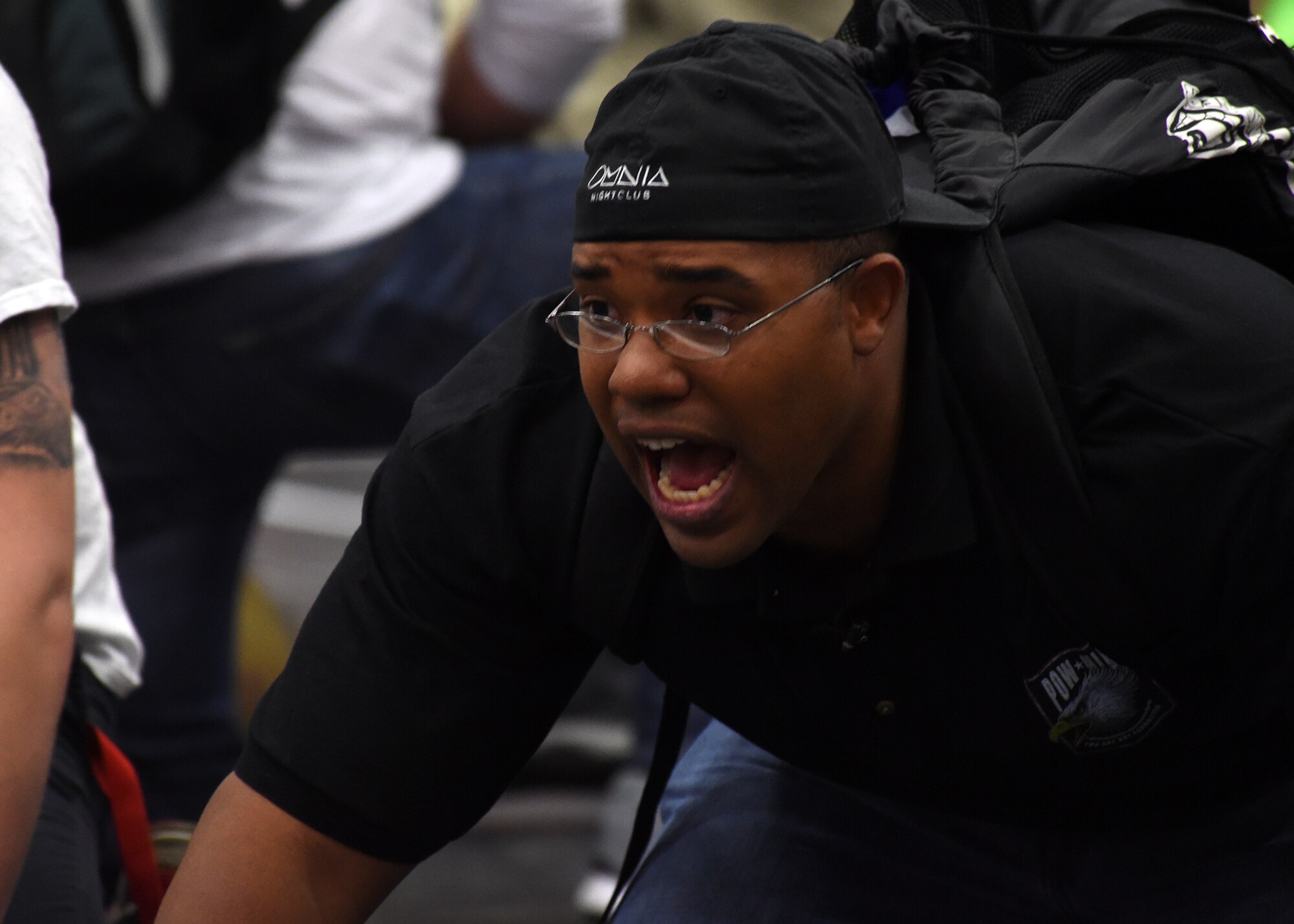 Morris Thomas, Children of Valor wrestling team coach, instructs a wrestler during a match at the state wrestling competition in Castle Rock, Colorado, Feb. 28, 2016. Thomas used wrestling as a guide while going through tough times during his youth. He now shares that sentiment with his wrestling team. (U.S. Air Force photo/Staff Sgt. Debbie Lockhart)