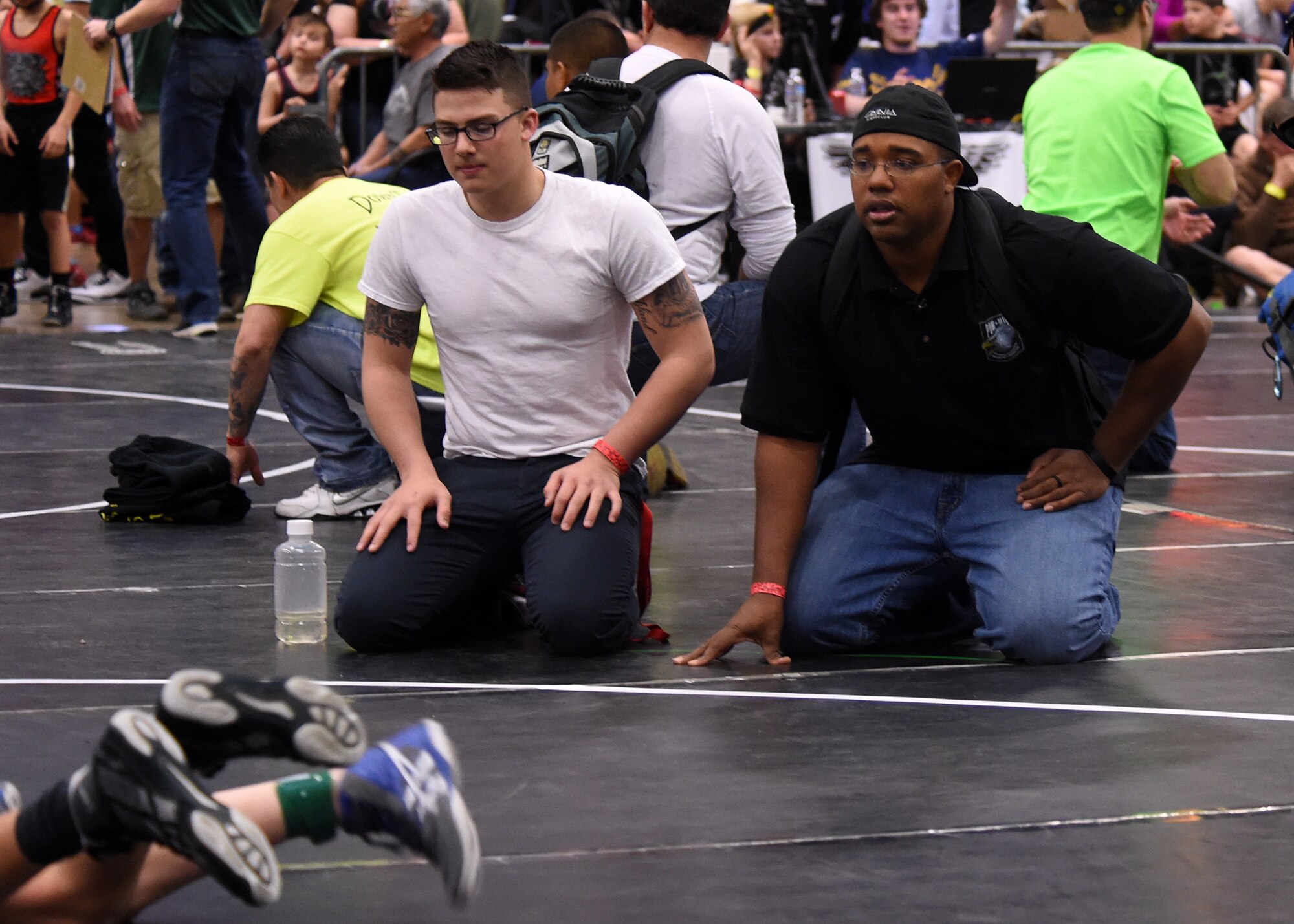 Morris Thomas, Children of Valor wrestling team coach, (right) instructs a wrestler during a match at the state wrestling competition in Castle Rock, Colorado, Feb. 28, 2016. Thomas, 50th Space Wing Safety Office, has been coaching for 10 years and has used his experience to create a wrestling club for Schriever Air Force Base children. (U.S. Air Force photo/Staff Sgt. Debbie Lockhart)