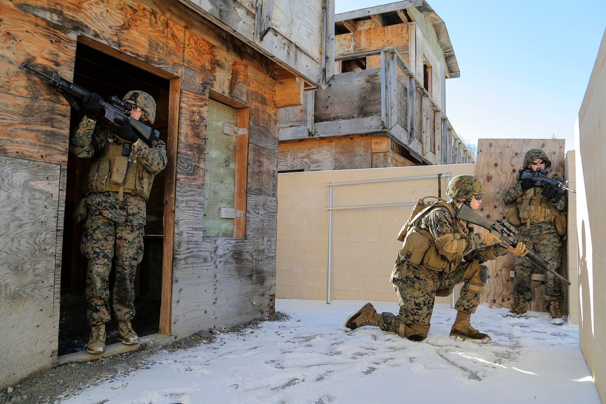 U.S. Marines assigned to Detachment Military Police Company D, 4th Law Enforcement Battalion, assault and clear a complex during military operations on urban terrain (MOUT) training at Joint Base Elmendorf-Richardson, Alaska, March 6, 2016. The MOUT training prepared the Marines for their upcoming deployment to Serbia where they will serve as military police advisors. (U.S. Air Force photo/Alejandro Pena)