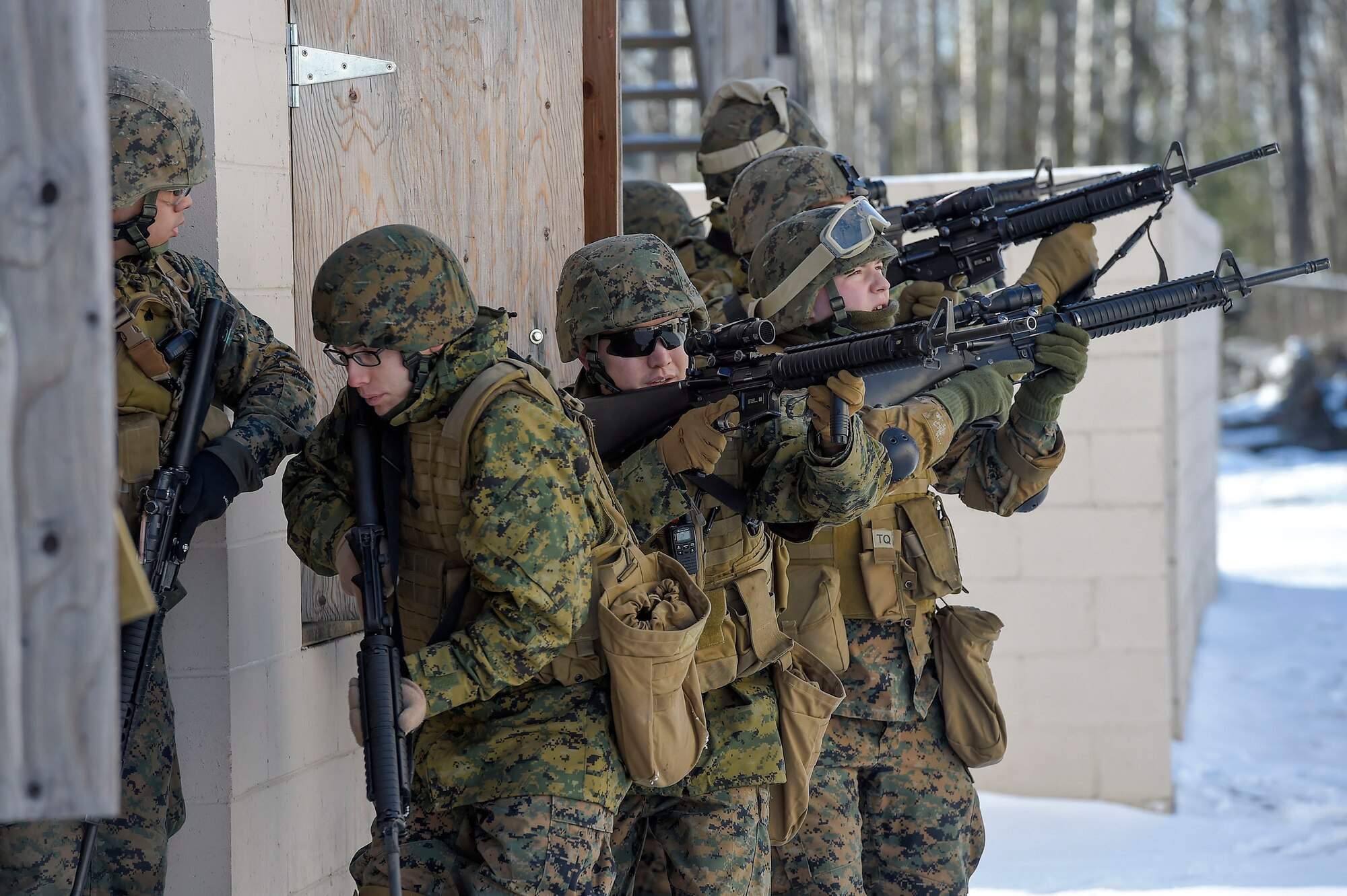 U.S. Marines assigned to Detachment Military Police Company D, 4th Law Enforcement Battalion, assault and clear a complex during military operations on urban terrain (MOUT) training at Joint Base Elmendorf-Richardson, Alaska, March 6, 2016. The MOUT training prepared the Marines for their upcoming deployment to Serbia where they will serve as military police advisors. (U.S. Air Force photo/Alejandro Pena)