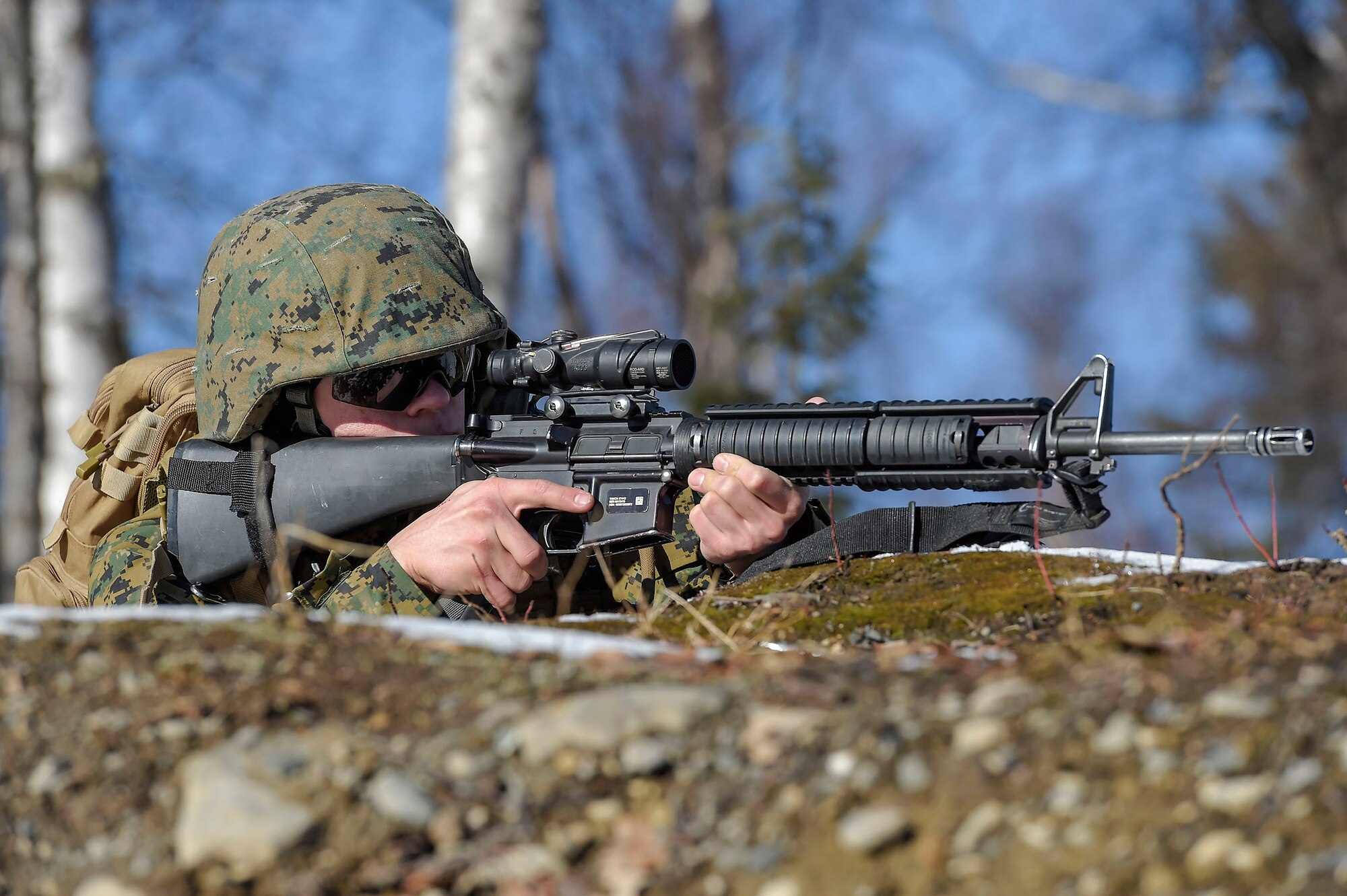 U.S. Marine Corps Lance Cpl. Artyom Artemenko, assigned to Detachment Military Police Company D, 4th Law Enforcement Battalion, provides security while fellow Marines clear a complex during military operations on urban terrain (MOUT) training at Joint Base Elmendorf-Richardson, Alaska, March 6, 2016. The MOUT training prepared the Marines for their upcoming deployment to Serbia where they will serve as military police advisors. (U.S. Air Force photo/Alejandro Pena)