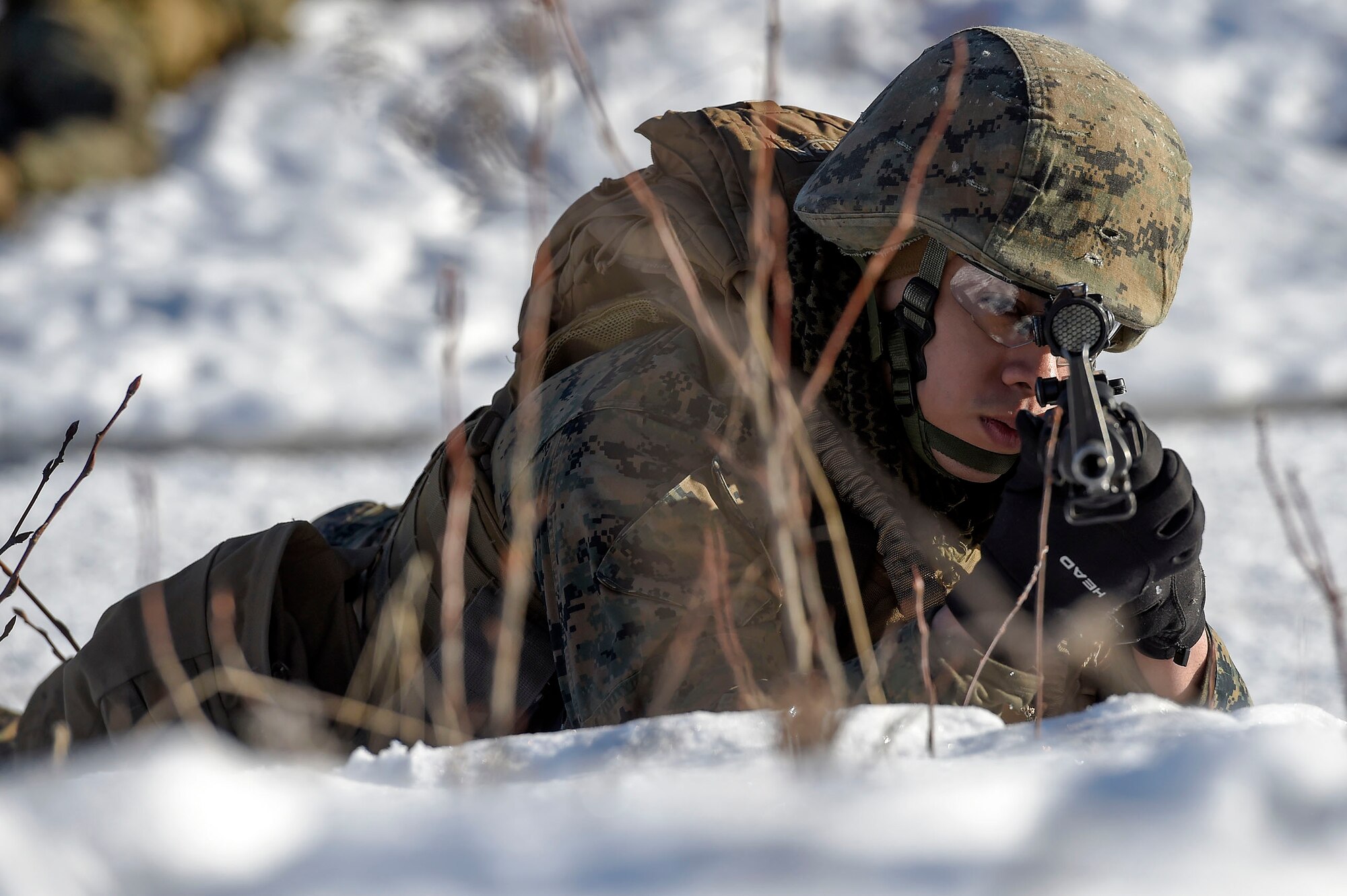 U.S. Marine Corps Cpl. Deion Delara, assigned to Detachment Military Police Company D, 4th Law Enforcement Battalion, watches his sector during a convoy security halt at Joint Base Elmendorf-Richardson, Alaska, March 6, 2016. The Marines conducted military operations on urban terrain training in preparation for their upcoming deployment to Serbia where they will serve as military police advisors. (U.S. Air Force photo/Alejandro Pena)