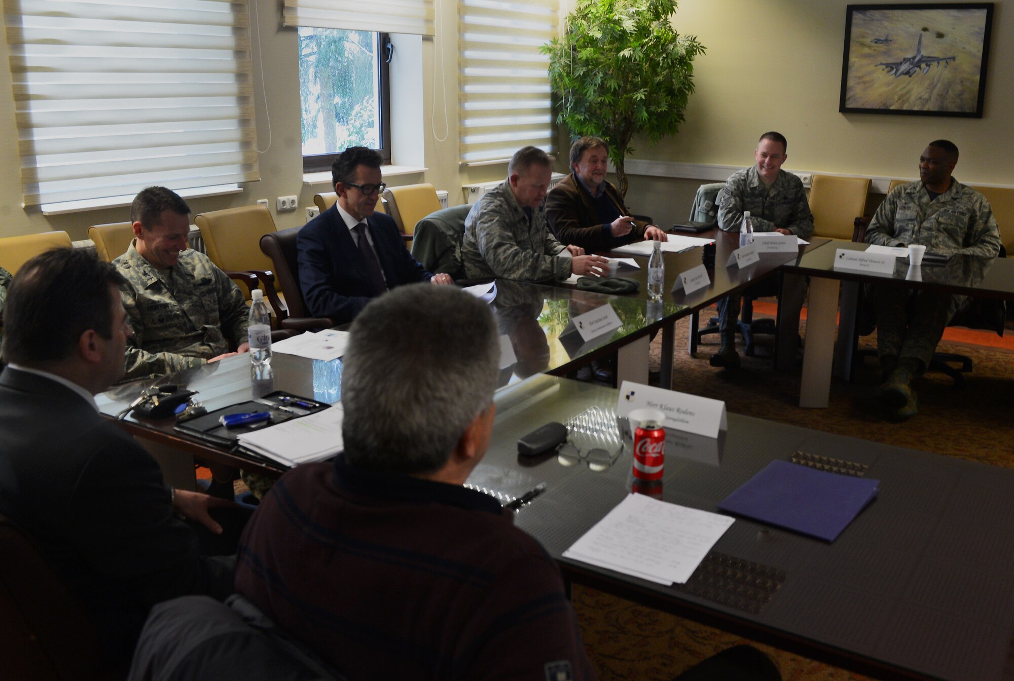Bernhard Schaefer, 52nd Fighter Wing community relations advisor, centered in front of the tree, acts as a translator between base and local community leaders during an information forum at Spangdahlem Air Base, Germany, March 4, 2016. Business and civic leaders from throughout the Eifel region attended the forum, which aimed to strengthen the partnership between the base and the surrounding host nation communities. (U.S. Air Force photo by 2nd Lt Meredith Mulvihill/Released)