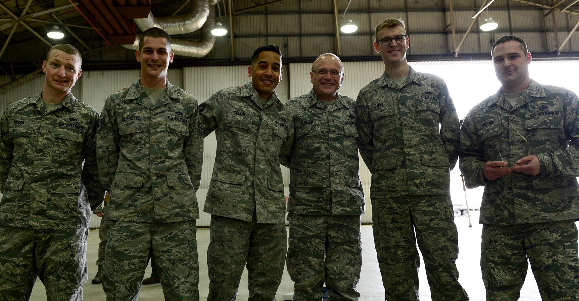 Maj. Gen. Andrew Mueller, (Center) Air Force Chief of Safety, presents Airmen from the 48th Component Maintenance Squadron Egress shop with the Aviation Maintenance Safety Award at Royal Air Force Lakenheath, England, March 7, 2016. The Egress Section team accomplished 3.3K explosive maintenance tasks and time changed over 450 egress system explosive components with zero discrepancies during fiscal year 2015. (U.S. Air Force photo by Senior Airman Dawn M. Weber/Released)