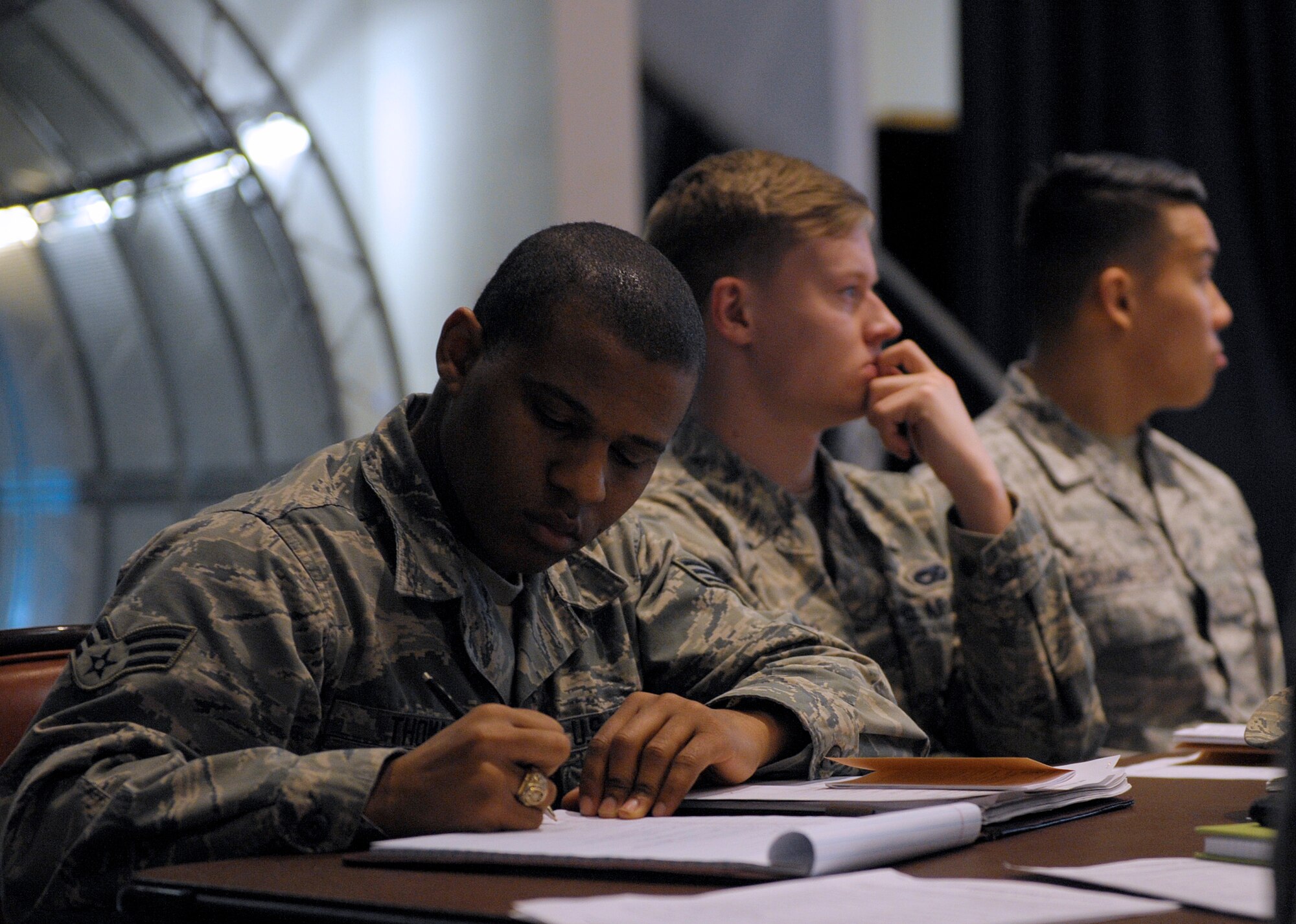 Senior Airman Justin Thomas, 83rd Network Operations Squadron Detachment 4 directory service technician, takes notes during the inaugural Airman Professional Enhancement Seminar March 7, 2016, at Ramstein Air Base, Germany. The Airman PES will be offered every other month, for a total of six seminars a year. (U.S. Air Force photo/Staff Sgt. Timothy Moore)