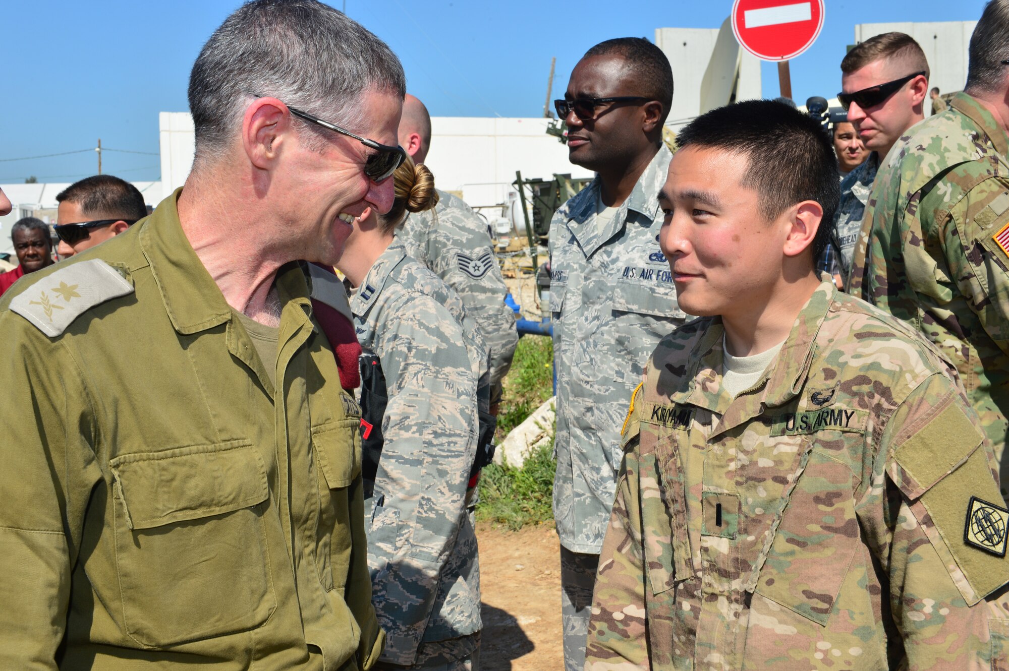 Lt. Gen. William Garrett, U.S. European Command deputy commander, meets 1st Lt. Kyle Kiriyama, 44th Expeditionary Signals Battalion platoon leader, during his visit of the exercise Juniper Cobra. Juniper Cobra is a biennial exercise held in Israel that trains on the ballistic missile defense, crisis resupply, foreign disaster response and foreign humanitarian assistance using computer simulations. Garrett recognized the efforts of three combat communications units working together for the first time in support of the exercise. (U.S. Air Force photo by Staff Sgt. Stephanie Longoria/Released)