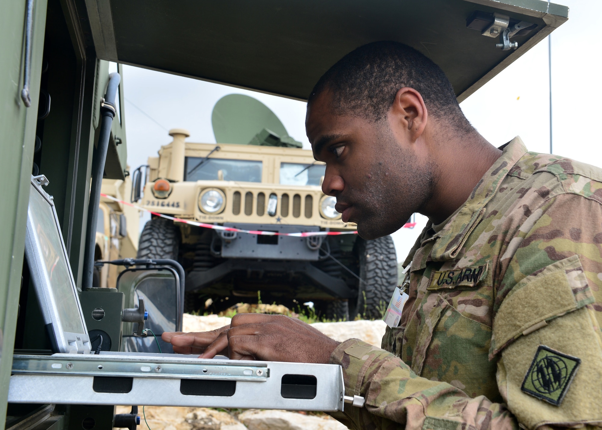 Sgt. Maurice Felder, 44th Expeditionary Signals Battalion Tactical Satellite (TACSAT) team chief, from Grafenwohr, Germany, troubleshoots the satellite connection during exercise Juniper Cobra 16 in Israel, Feb. 22, 2016. Juniper Cobra uses ballistic missile defense computer simulations to train U.S. and Israeli service members while reinforcing a strong military relationship. For the first time, Airmen from the 1st Combat Communications Squadron, 52nd CBCS and soldiers from the 44th Expeditionary Signals Battalion work together to support U.S. European Command. (U.S. Air Force photo by Staff Sgt. Stephanie Longoria/Released)
