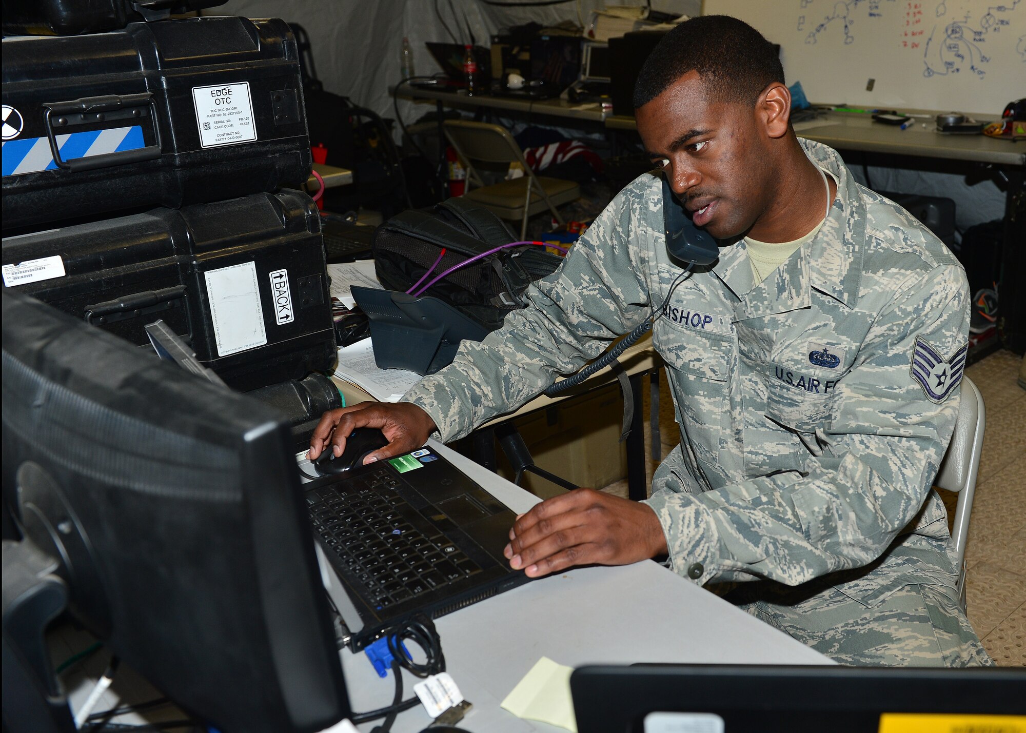 Staff Sgt. Shimir Bishop, 1st Combat Communications Squadron tactical network operations supervisor, from Ramstein Air Base, Germany, modifies a user account during exercise Juniper Cobra 16 in Israel, Feb. 22. Juniper Cobra uses ballistic missile defense computer simulations to train U.S. and Israeli service members while reinforcing a strong military relationship. For the first time, Airmen from the 1st CBCS, 52nd CBCS and soldiers from the 44th Expeditionary Signals Battalion work together to support U.S. European Command. (U.S. Air Force photo by Staff Sgt. Stephanie Longoria/Released)