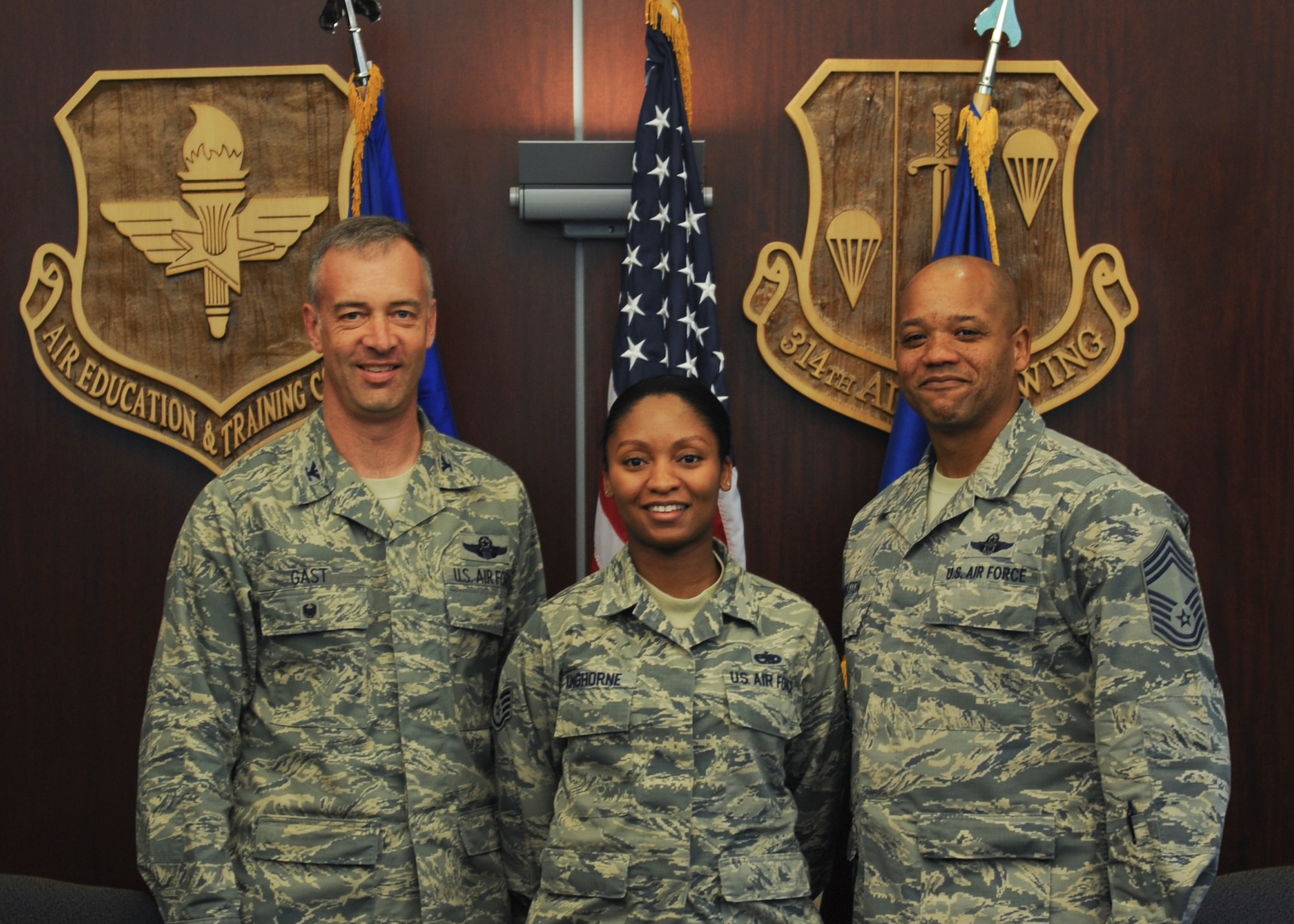 Col. Jeffrey Gast, 314th Airlift Wing vice commander, and Chief Master Sgt. Staff Sgt. Lewis Holston, 314th Operations Group superintendent, congratulate Staff Sgt. Laketa Kinghorne, 314th Aircraft Maintenance Squadron commander’s support staff noncommissioned officer in charge, for her selection as Combat Airlifter of the Week March 2, 2016, at Little Rock Air Force Base, Ark. (U.S. Air Force photo/Senior Airman Harry Brexel) 