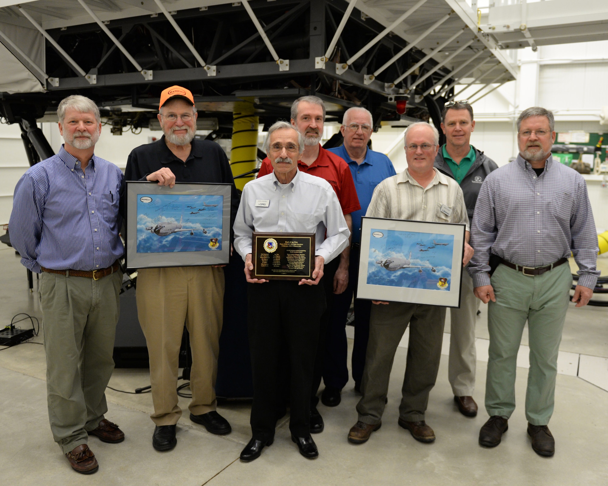 Instructors and technicians from Delaware Resource Group pose for a photograph after the retirement of the KC-135 flight simulator from Pease Air National Guard Base, New Hampshire, March, 9, 2016.  DRG supports the daily operation of the simulator. The simulator is being retired to make way for a new KC-46 weapons trainer slated to arrive in the spring of 2017. (U.S. Air National Guard photo by Staff Sgt. Curtis J. Lenz)