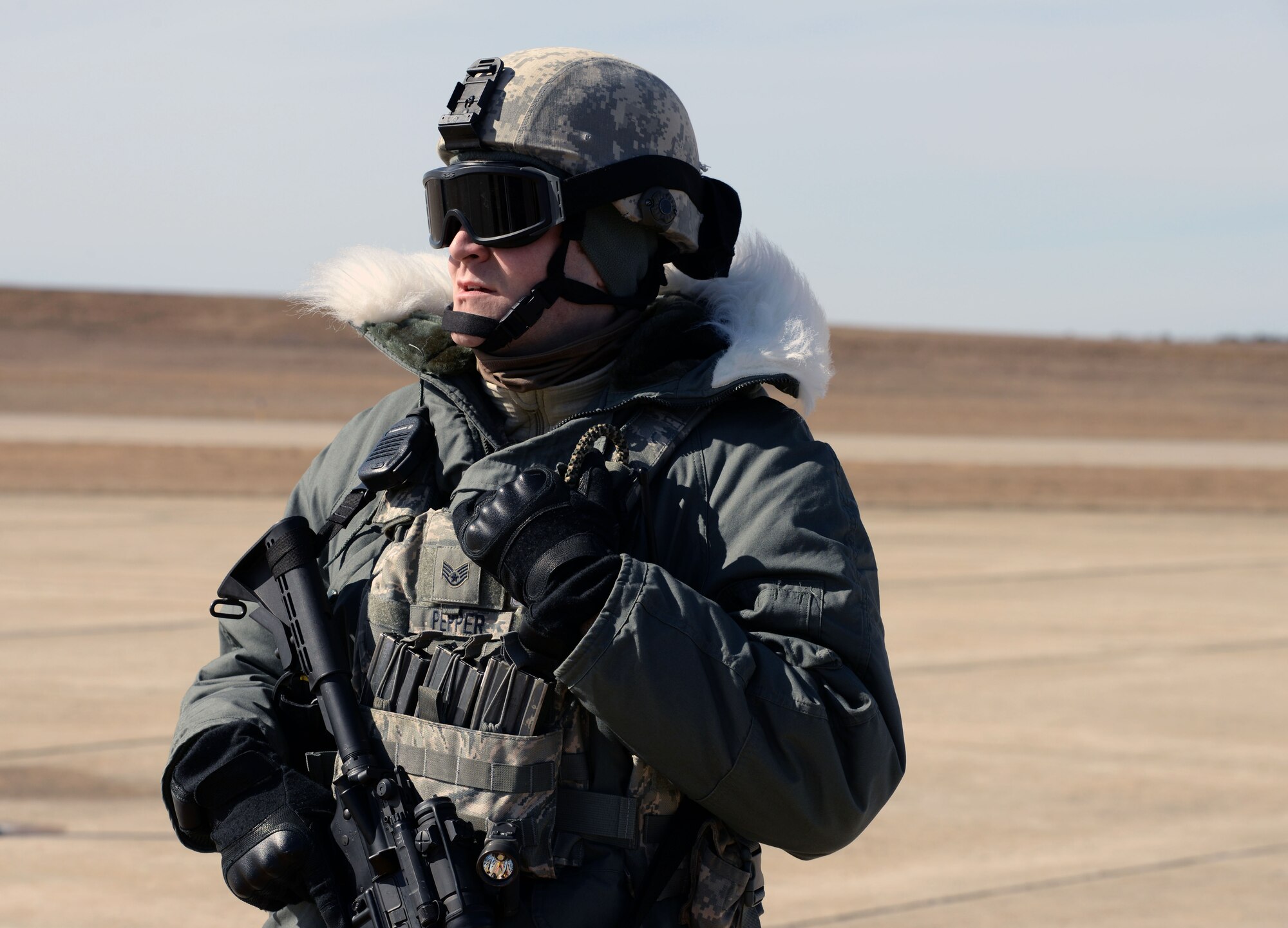 U.S. Air Force Staff Sgt. John R. Pepper III, a security non-commissioned officer assigned to the 157th Security Forces Squadron, New Hampshire Air National Guard, provides security on the flightline during a training exercise, Pease Air National Guard Base, N.H. March 5, 2016. (U.S. Air National Guard photo by Staff Sgt. Curtis J. Lenz)