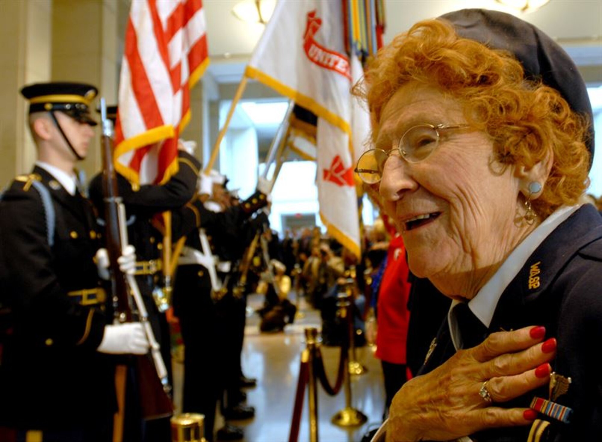 Betty Wall Strohfus, right, a former pilot with the Women Airforce Service Pilots (WASP), sings the national anthem during the Congressional Gold Medal ceremony at the U.S. Capitol in Washington, D.C., March 10, 2010. The Congressional Gold Medal is the highest civilian award bestowed by Congress. The WASP program, established during World War II, trained women to fly noncombat military missions. (U.S. Air Force photo/Staff Sgt. J.G. Buzanowski) 
