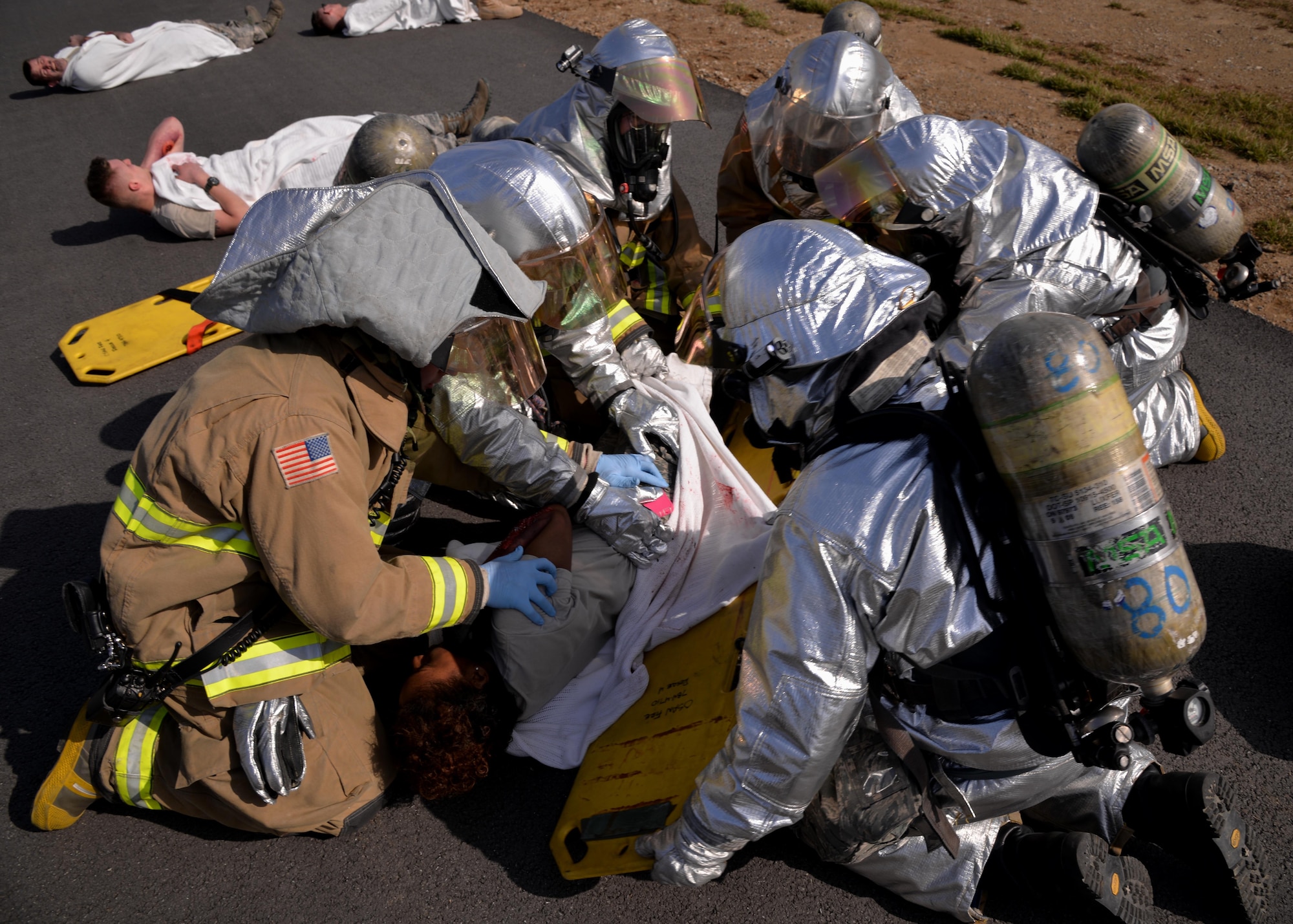 Firefighters from the 51st Civil Engineer Squadron evaluate and provide medical care to a victim during a simulated emergency March 9, 2016, at Osan Air Base, Republic of Korea. The simulated emergency was part of Exercise Beverly Midnight 16-01. The readiness exercise is designed to test the ability of 51st Fighter Wing members to fight and survive during simulated combat conditions. (U.S. Air Force photo by Staff Sgt. Benjamin Sutton/Released)