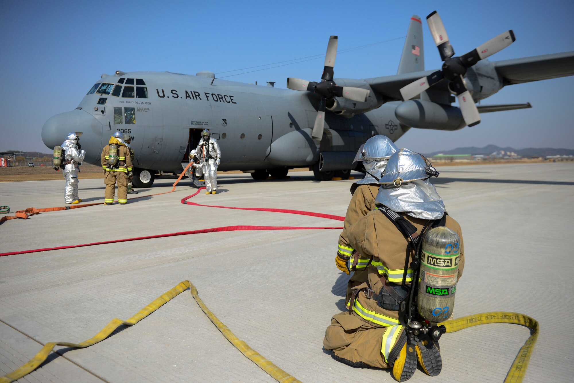Firefighters from the 51st Civil Engineer Squadron surround a C-130H Hercules cargo aircraft that received simulated small-arms fire during Exercise Beverly Midnight 16-01, March 9, 2016, at Osan Air Base, Republic of Korea. First responders from the 51st Fighter Wing responded to the scene in order to provide medical care to mock wounded personnel. Beverly Midnight is aimed at measuring Team Osan’s capability to survive and operate during simulated combat operations. (U.S. Air Force photo by Staff Sgt. Jonathan Steffen/Released)