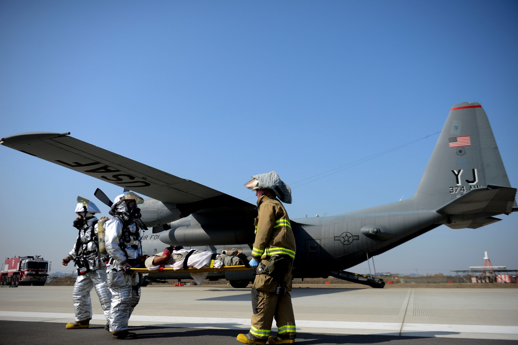 Firefighters from the 51st Civil Engineer Squadron transport a simulated wounded Airman during readiness Exercise Beverly Midnight 16-01, March 9, 2016, at Osan Air Base, Republic of Korea. Emergency responders provided care for the mock wounded after a C-130H Hercules cargo aircraft received simulated small-arms fire during landing. (U.S. Air Force photo by Staff Sgt. Jonathan Steffen/Released)