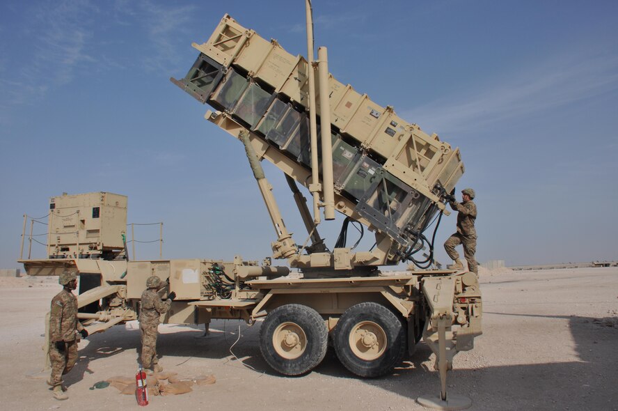 Sgt. Charles Glover (Left) from Houston, Texas, Pfc. Michael Schultz (Center) from Tampa, Florida, and Pfc. James Weaver (Right), from Steelville, Missouri, all 1-62 Delta Battery Air Defense Artillery Regiment Patriot station launcher operators and maintainers, prepare a Patriot missile to fire during an operational readiness exercise at Al Udeid Air Base, Qatar Mar. 4. The Patriot missiles at AUAB protect the base from a variety of airborne threats including tactical ballistic missiles and drones.  (U.S. Air Force photo by Tech. Sgt. James Hodgman/Released)