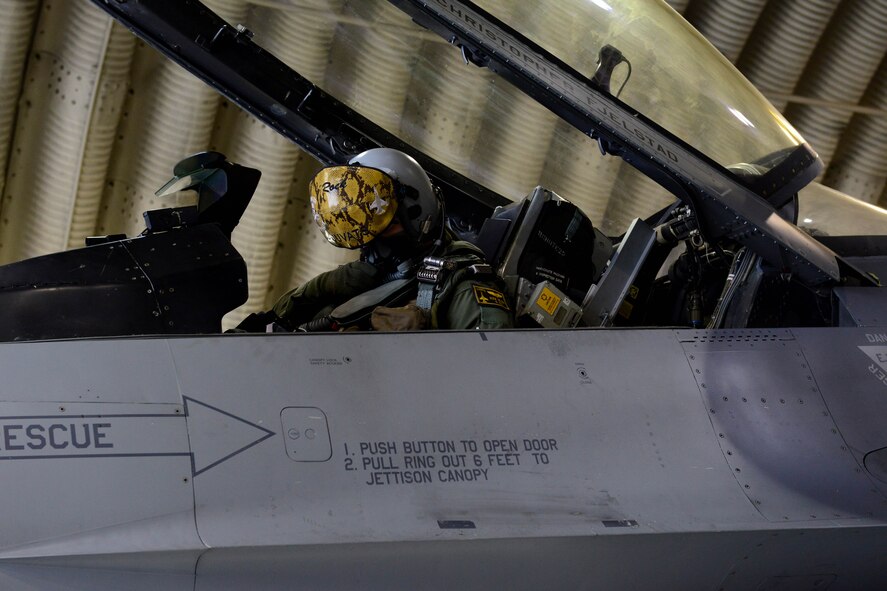 U.S. Air Force Capt. Phillip Wilson, 80th Fighter Squadron b-flight commander attaches his gear during the Beverly Midnight 16-01 exercise Mar. 9, 2016. The high ops tempo combined with challenging exercise conditions ensured Wolf Pack Airmen are able to execute contingency operations while building confidence and unit cohesion. (U.S. Air Force photo by Senior Airman Ashley L. Gardner/ Released)