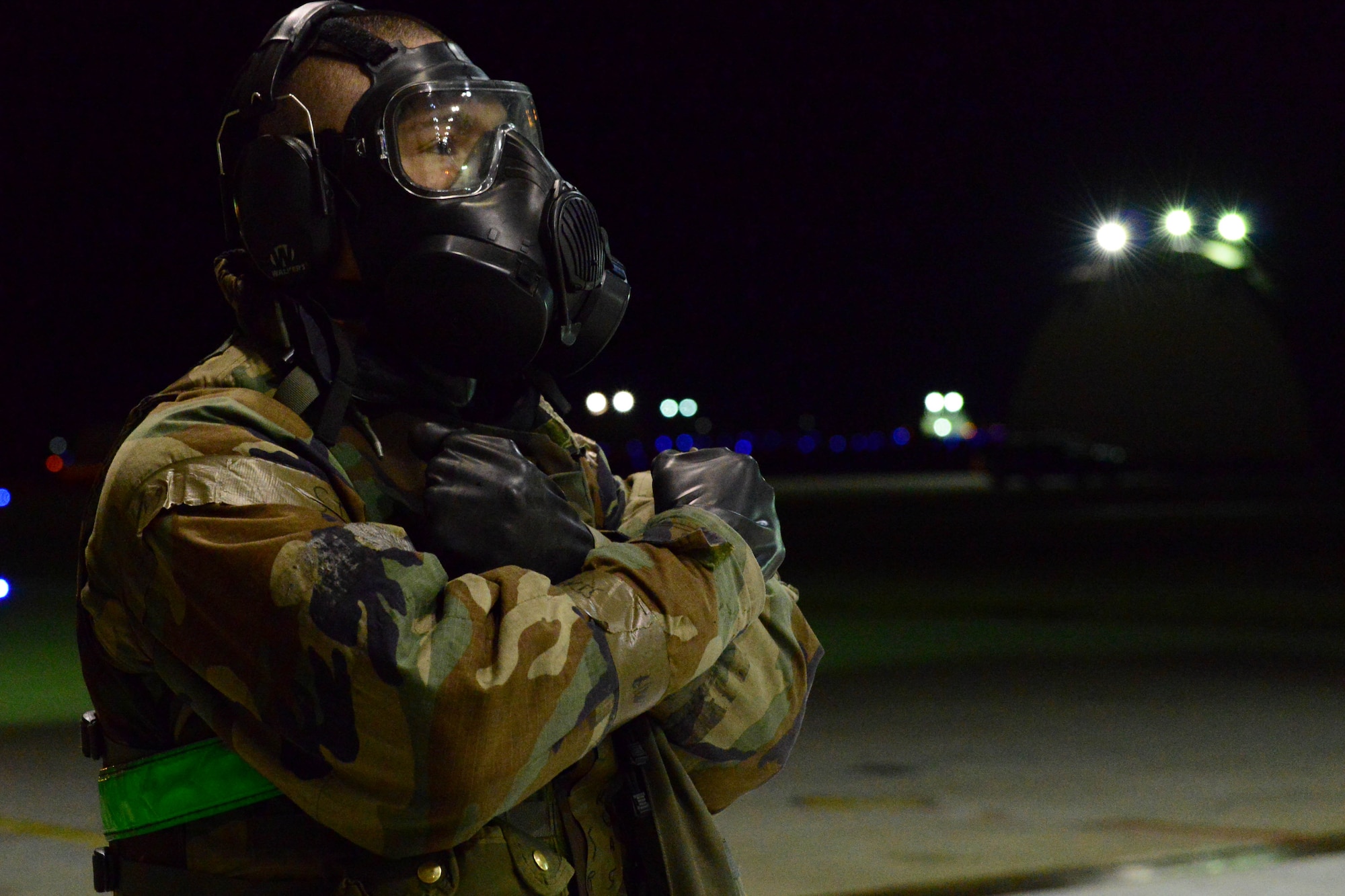 U.S. Air Force Senior Airman Alexis Vargas, 35th Fighter Squadron weapons load crew member stands waiting to launch a jet during the Beverly Midnight 16-01 exercise Mar. 10, 2016. The high ops tempo combined with challenging exercise conditions ensured Wolf Pack Airmen are able to execute contingency operations while building confidence and unit cohesion.  (U.S. Air Force photo by Senior Airman Ashley L. Gardner/ Released)