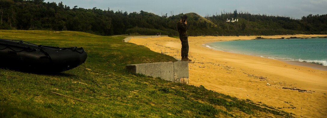 U.S. Marine Corps 1st Lt. Caleb J. Havens observes the Japan Ground Self-Defense Force conduct amphibious operations Mar. 9 at Kin Blue, Okinawa, Japan. The U.S. Marines and JGSDF service members observed and conducted raid missions, amphibious training and scout swimmer classes. Havens is the executive officer for Company A, 3rd Reconnaissance Battalion, 3rd Marine Division, III Marine Expeditionary Force. (U.S. Marine photo by Cpl. Tyler S. Giguere/Released)