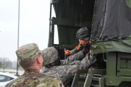 Louisiana National Guard members from the 2-108th Cavalry Regiment in Shreveport drop off evacuees at a collection point set up at Parkway High School in Bossier City during flood response operations, March 9, 2016. 