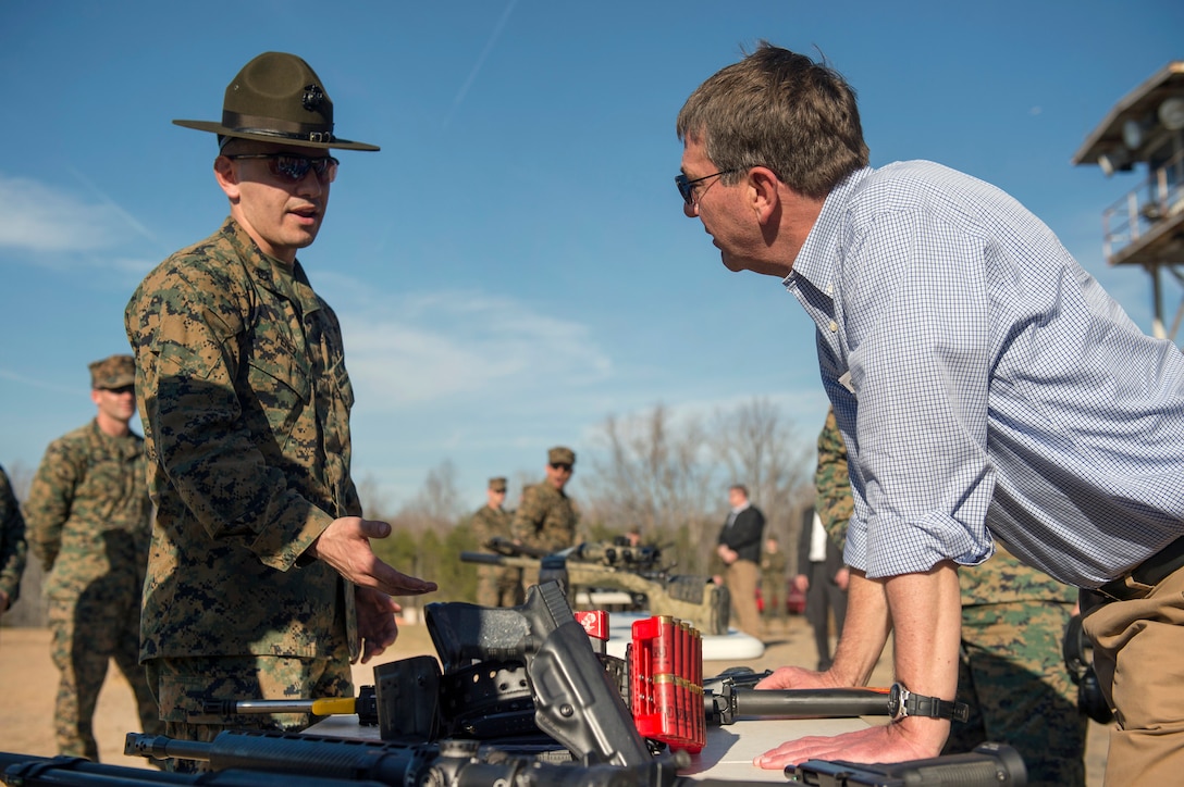 Defense Secretary Ash Carter listen as a Marine shows him various weapons the Marines use as he tours the Weapons Training Battalion on Marine Corps Base Quantico, Va., March 9, 2016. DoD photo by Air Force Senior Master Sgt. Adrian Cadiz