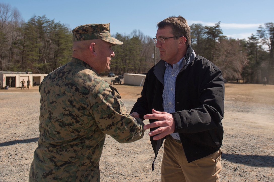 Defense Secretary Ash Carter shakes hands with Marine Corps Brig. Gen. Austin Renforth before they observe training on Marine Corps Base Quantico, Va., March 9, 2016. Renforth is the commanding general of the base's Training Command. DoD photo by Air Force Senior Master Sgt. Adrian Cadiz